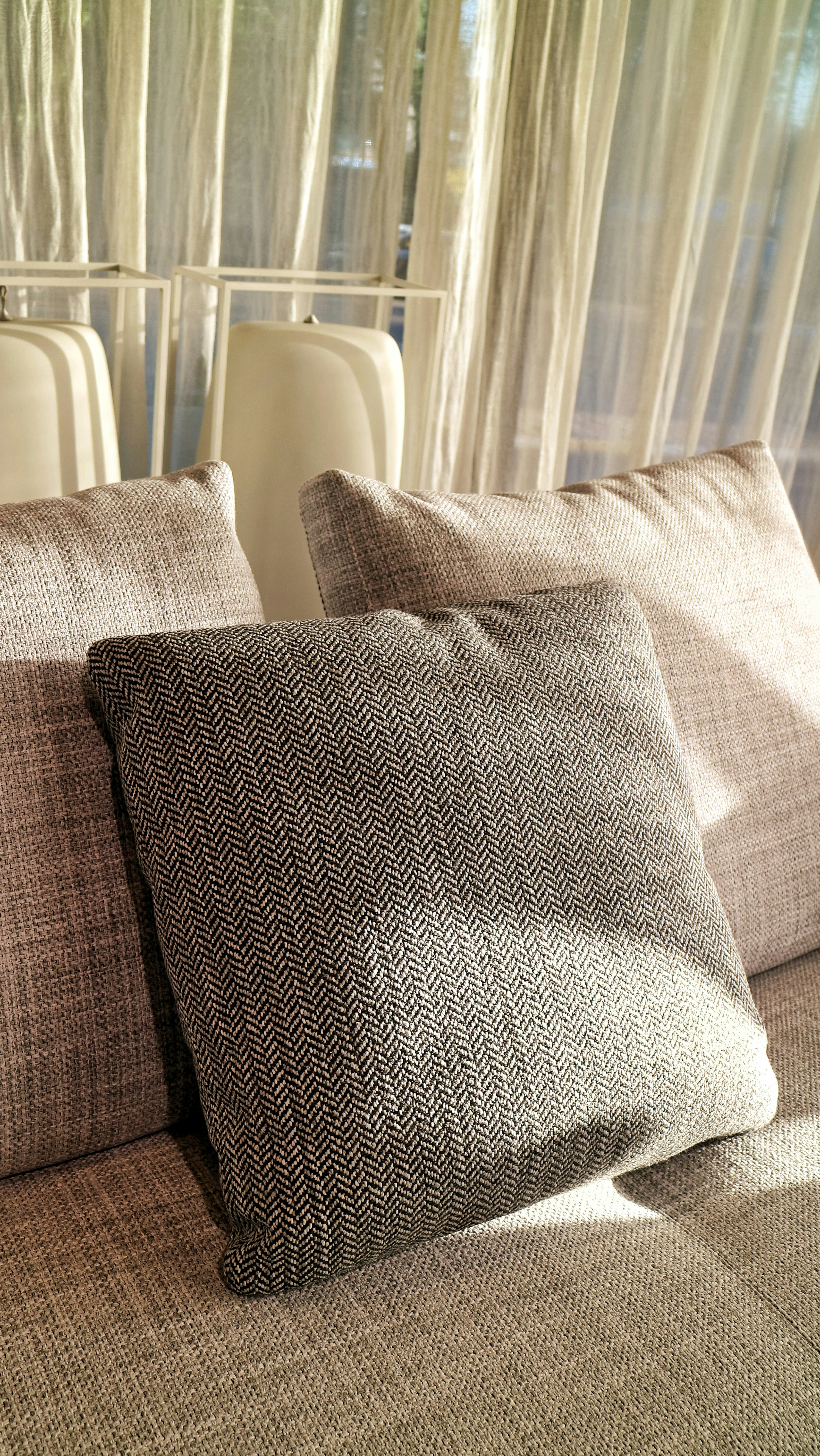 a close up of two pillows on a bed