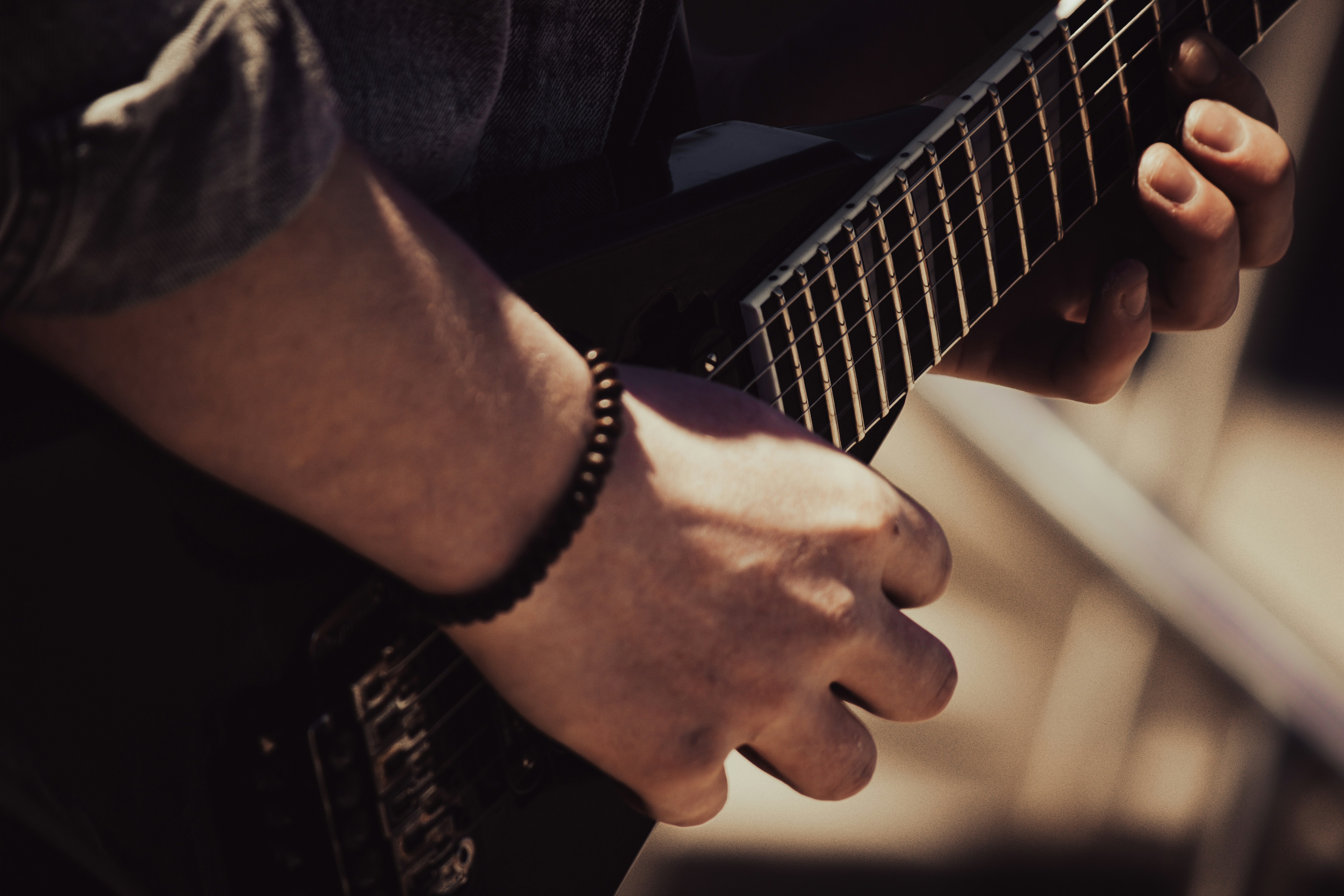 Man fretting a guitar