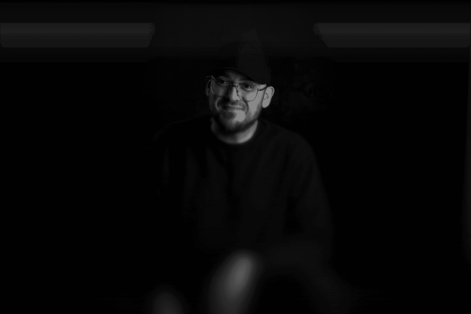 Spacious open-plan office with rows of desks and striking circular ceiling lights.