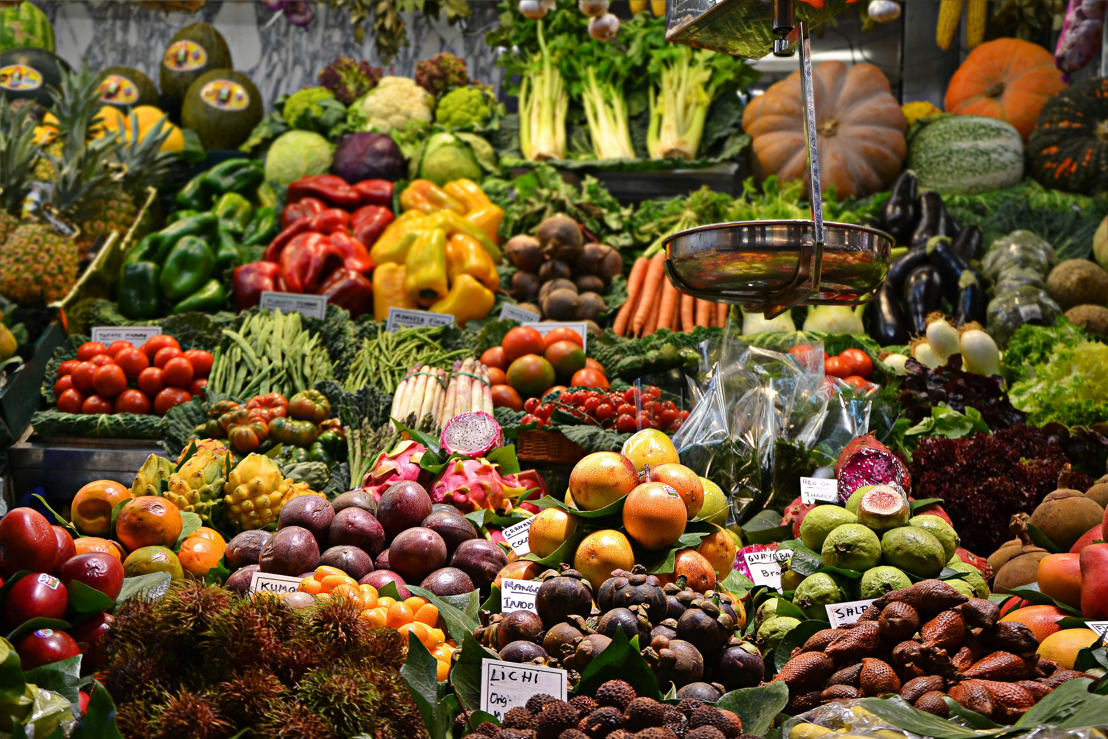 a market showing a wide variety of fruits and vegetables.