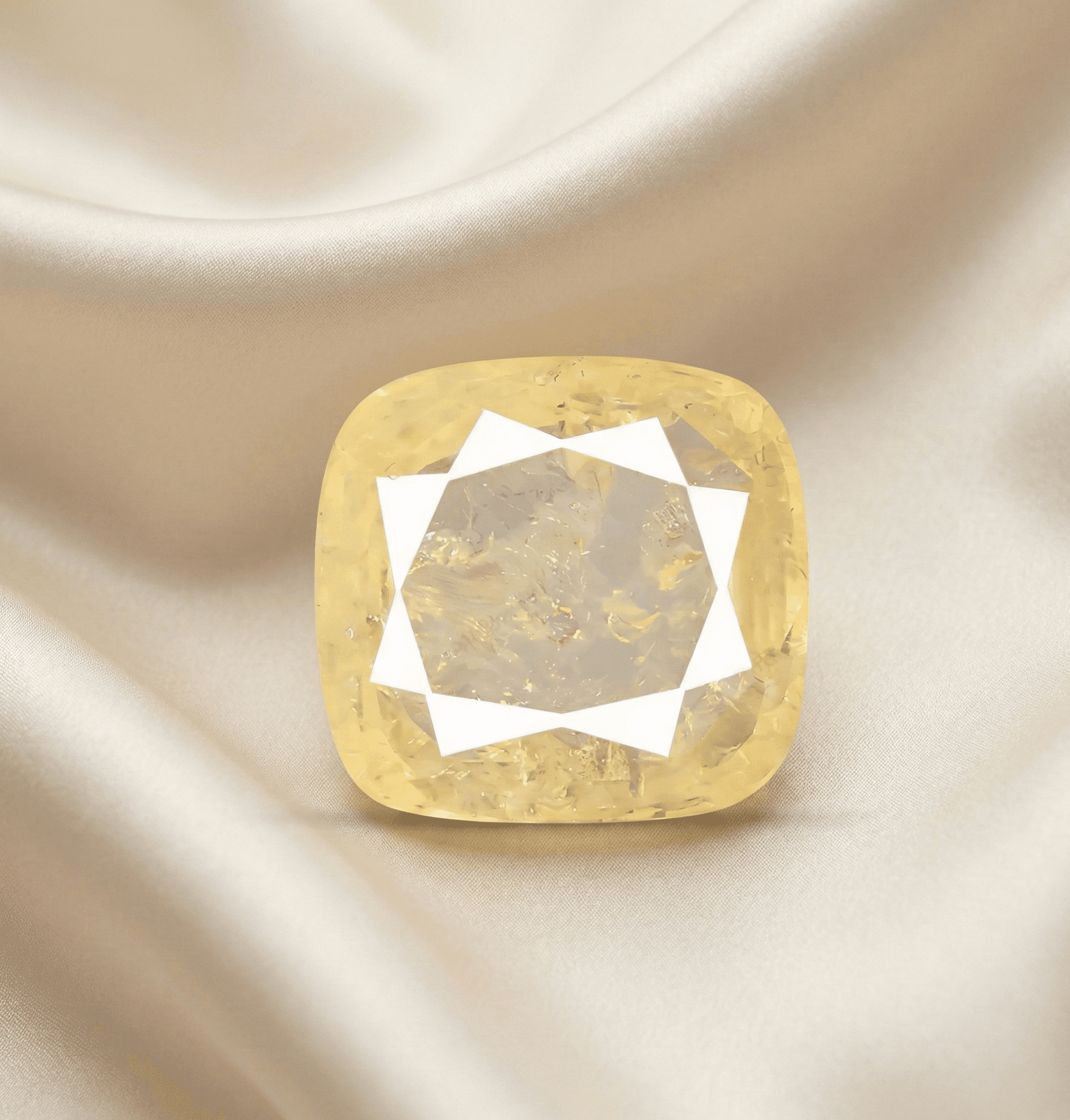 Square-cut gemstone on a beige fabric background