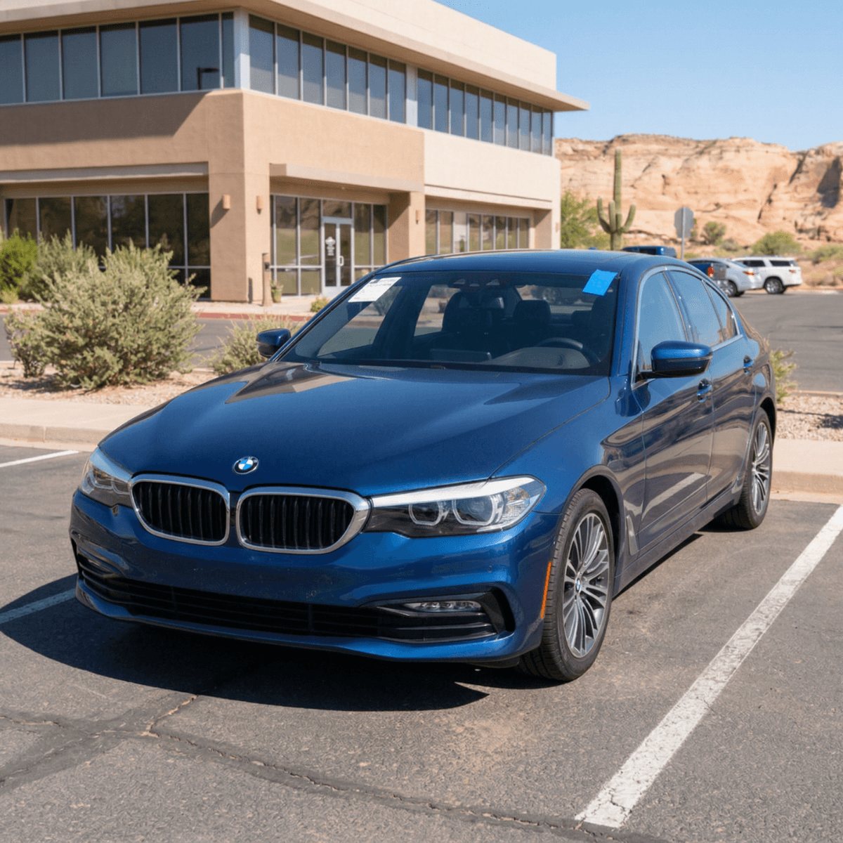 Blue BMW 3 Series sedan with a flawless new windshield parked at a Page, AZ apartment complex