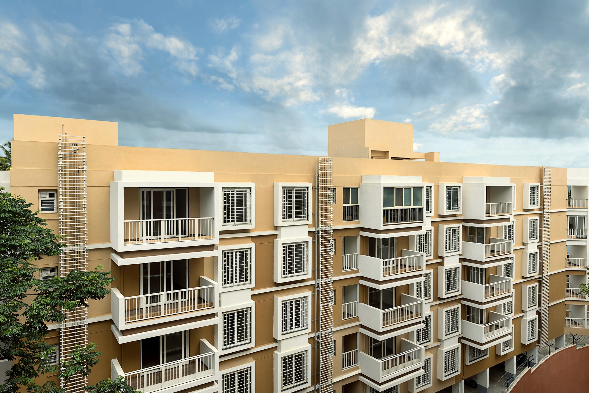 Aerial view of a winding road cutting through rocky terrain with patches of grass.