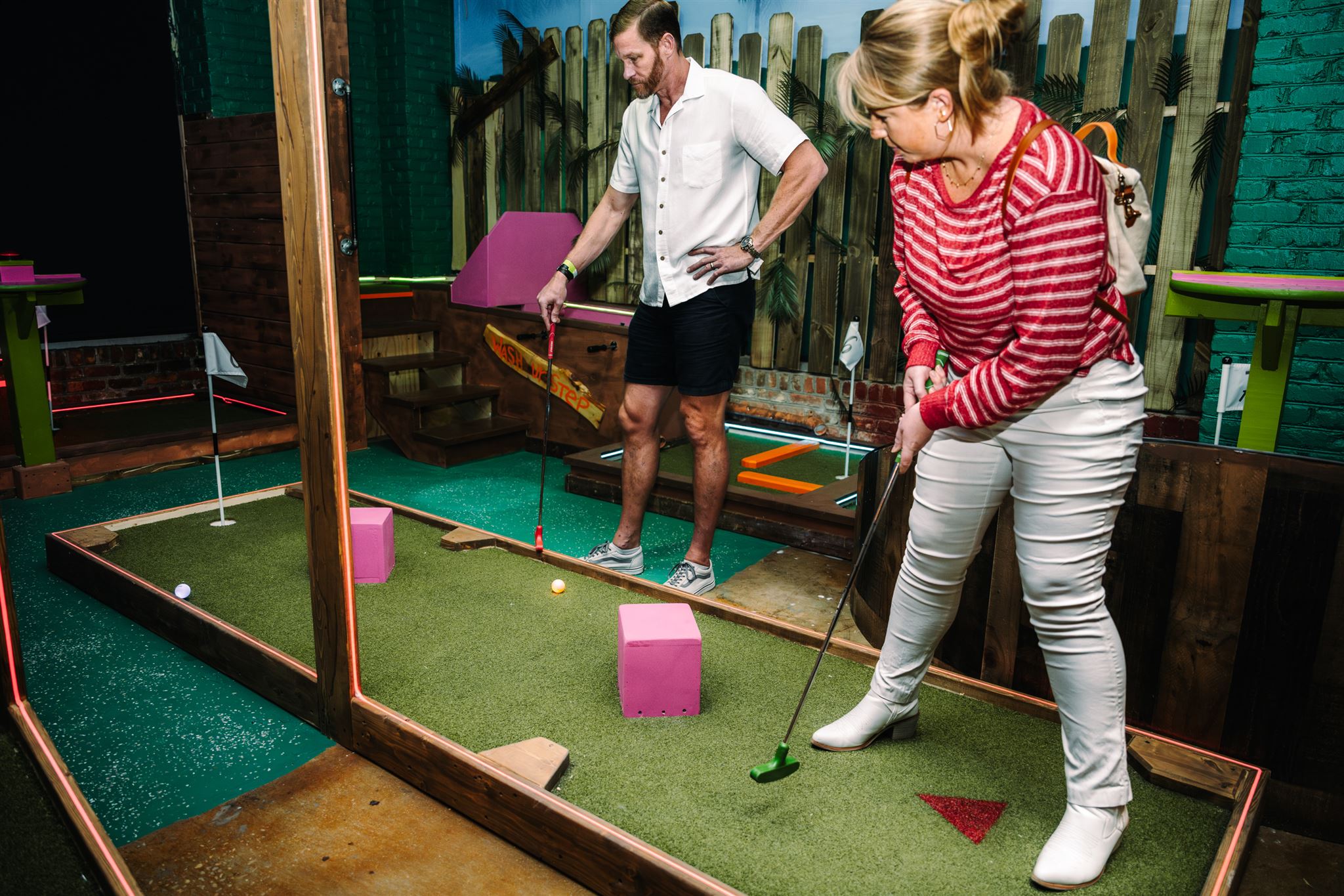 Family playing mini golf in charleston