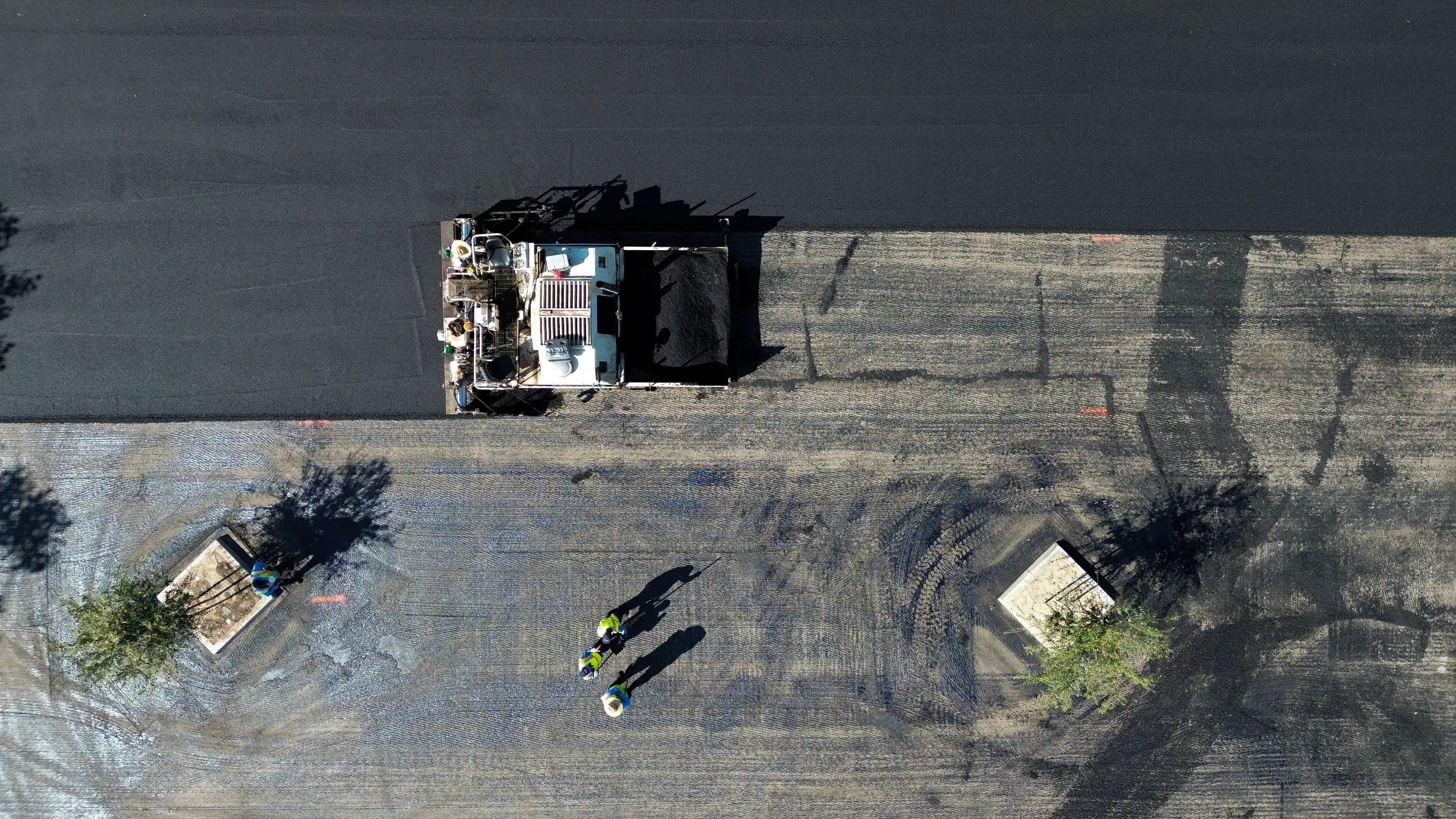 Aerial photo of asphalt crew prepping subgrade before paving new asphalt