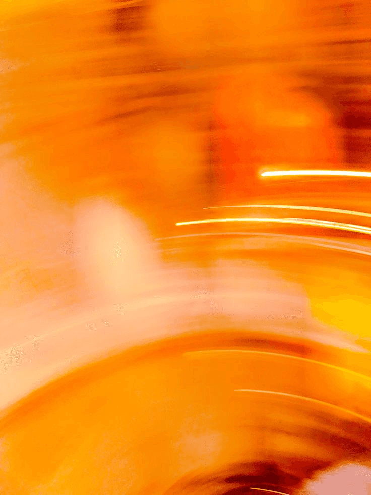 Abstract orange visual with soft blurred motion and light streaks, representing reduced processing and greater nutrient retention in dog food