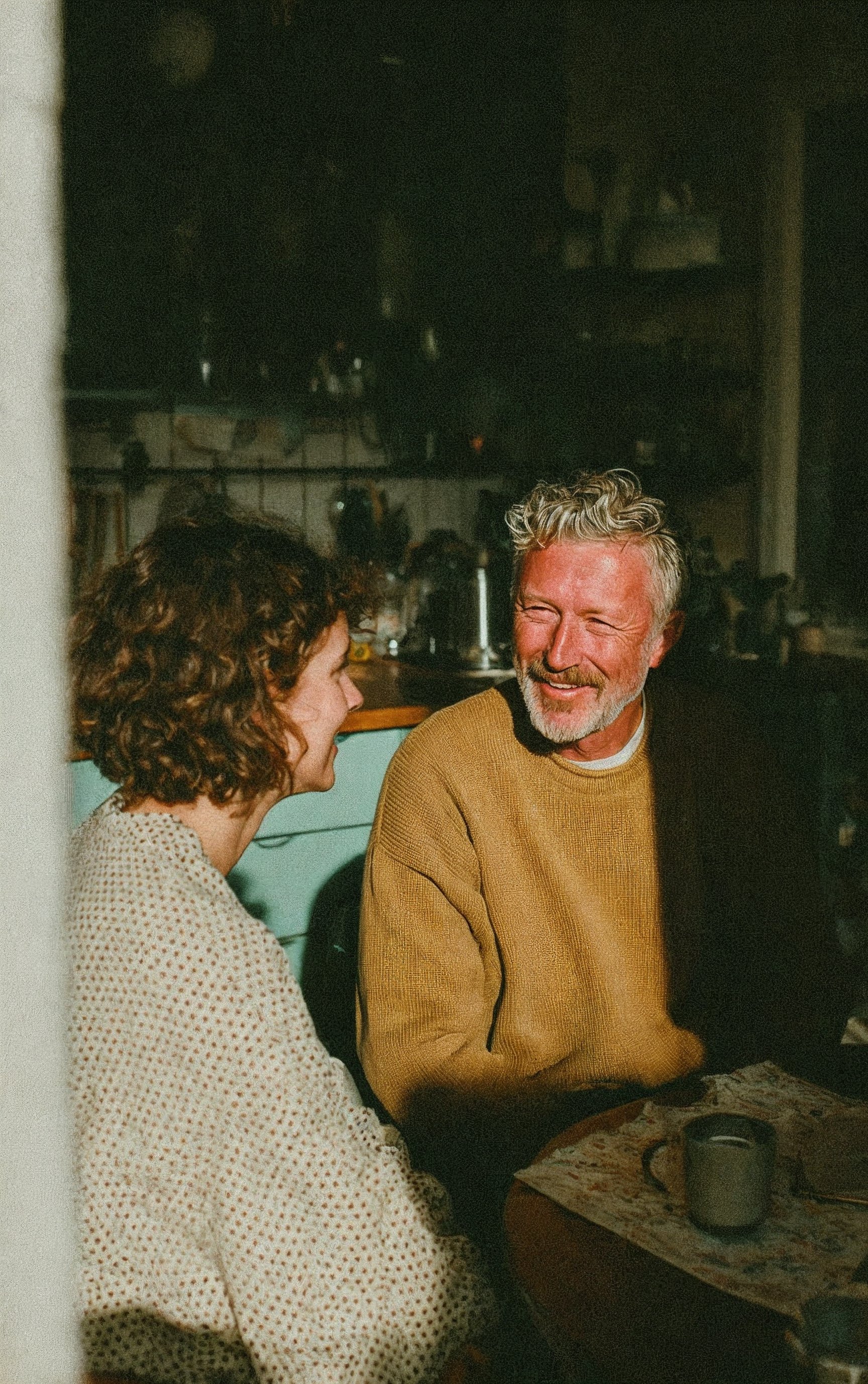woman sitting while working on laptop and smiling