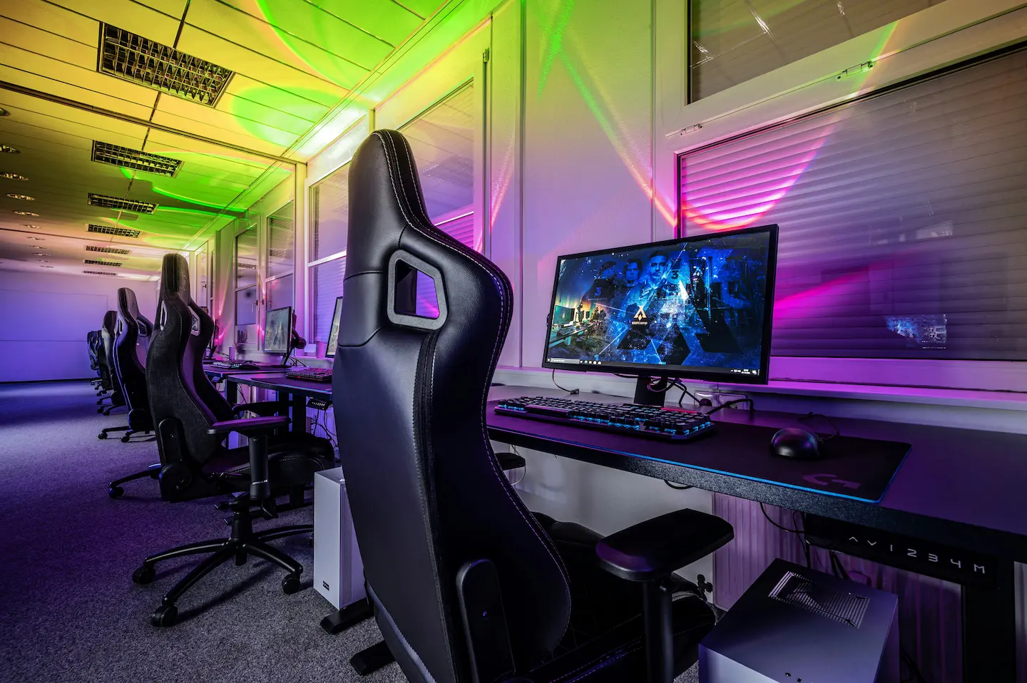 colorful-room-with-gaming-chairs-in-front-of-monitors-ingame