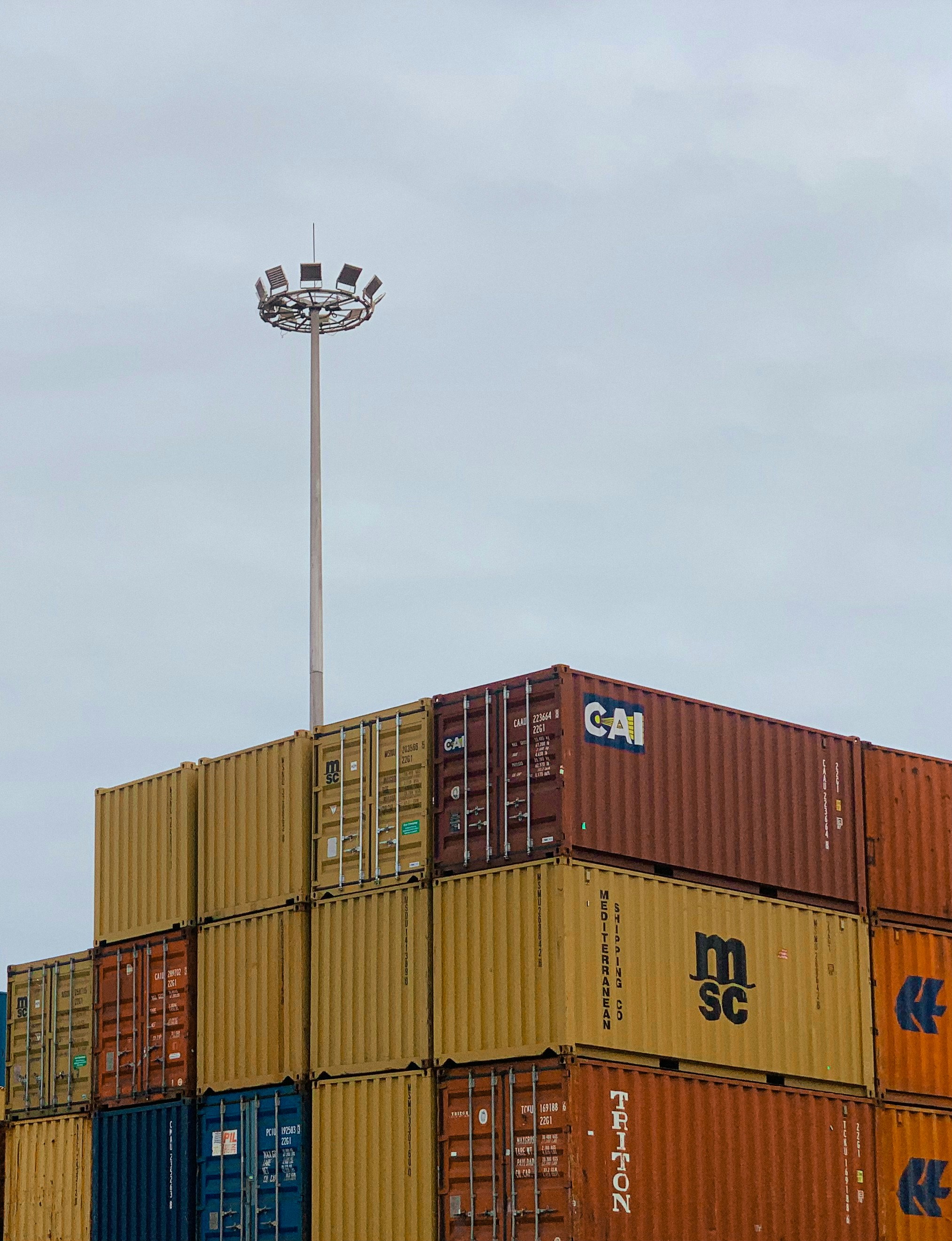 A large stack of shipping containers sitting on top of each other