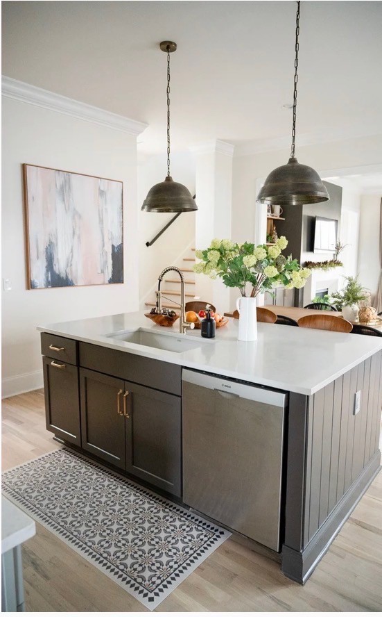 Modern bathroom featuring wooden cabinetry, a bathtub, a sleek sink, and natural light from a window.