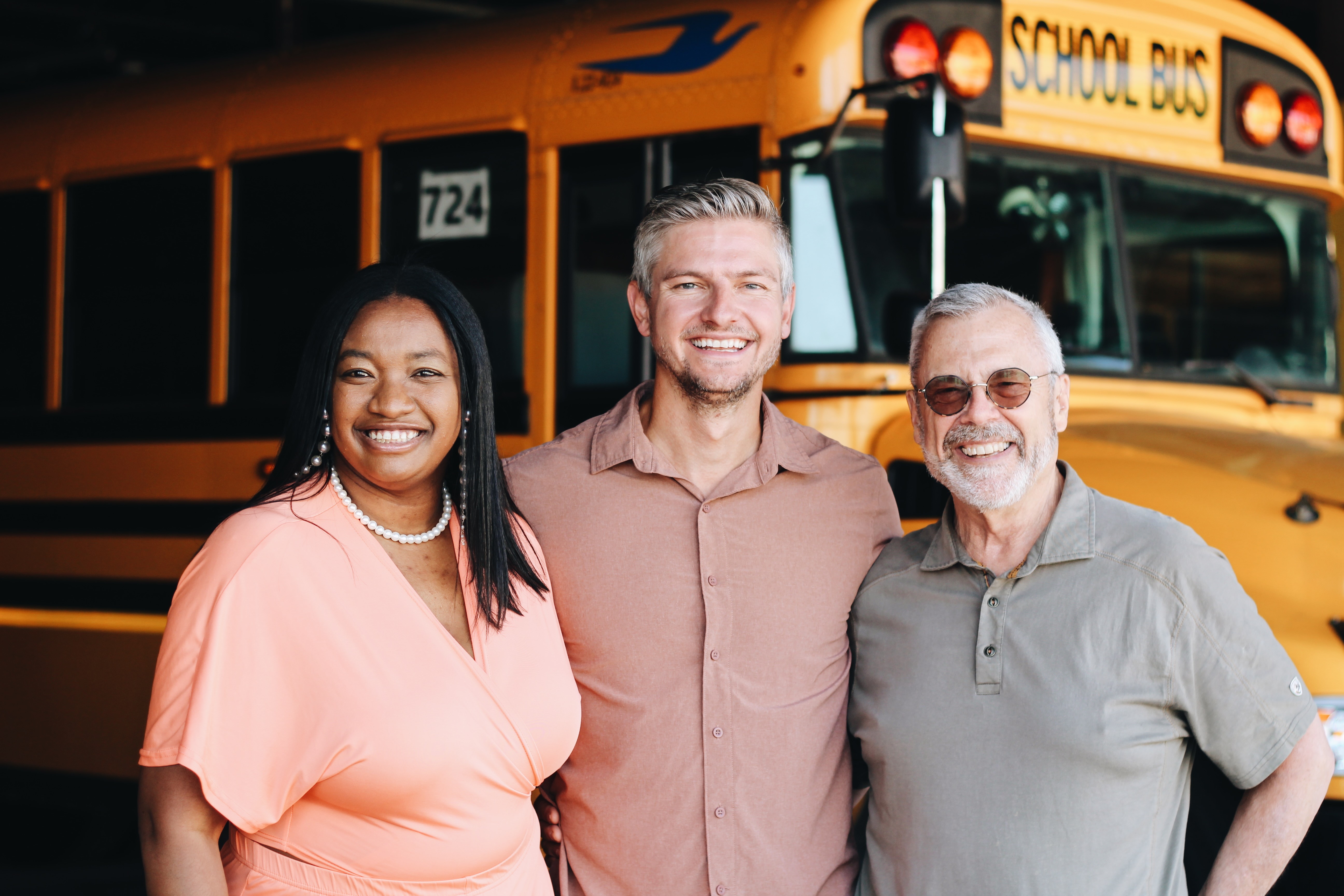 three women sitting beside wooden table
