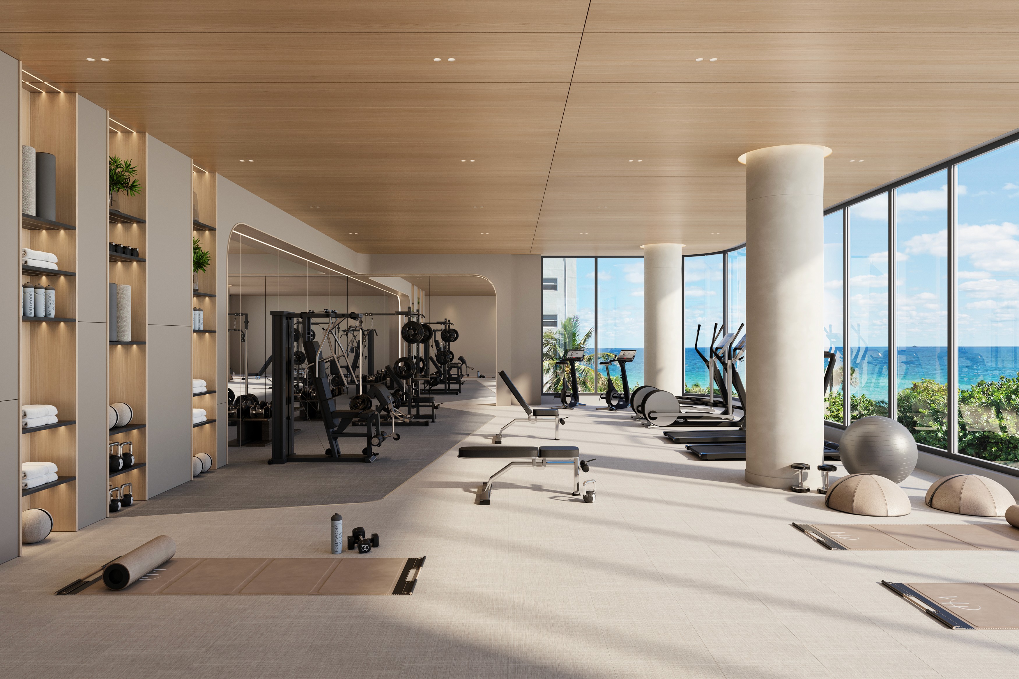 State-of-the-art condo gym in Hollywood Beach Florida with modern fitness equipment and floor-to-ceiling ocean views.