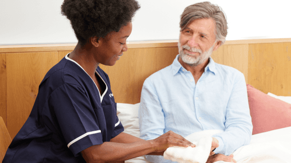 Florence nurse taking care of male patient in bed