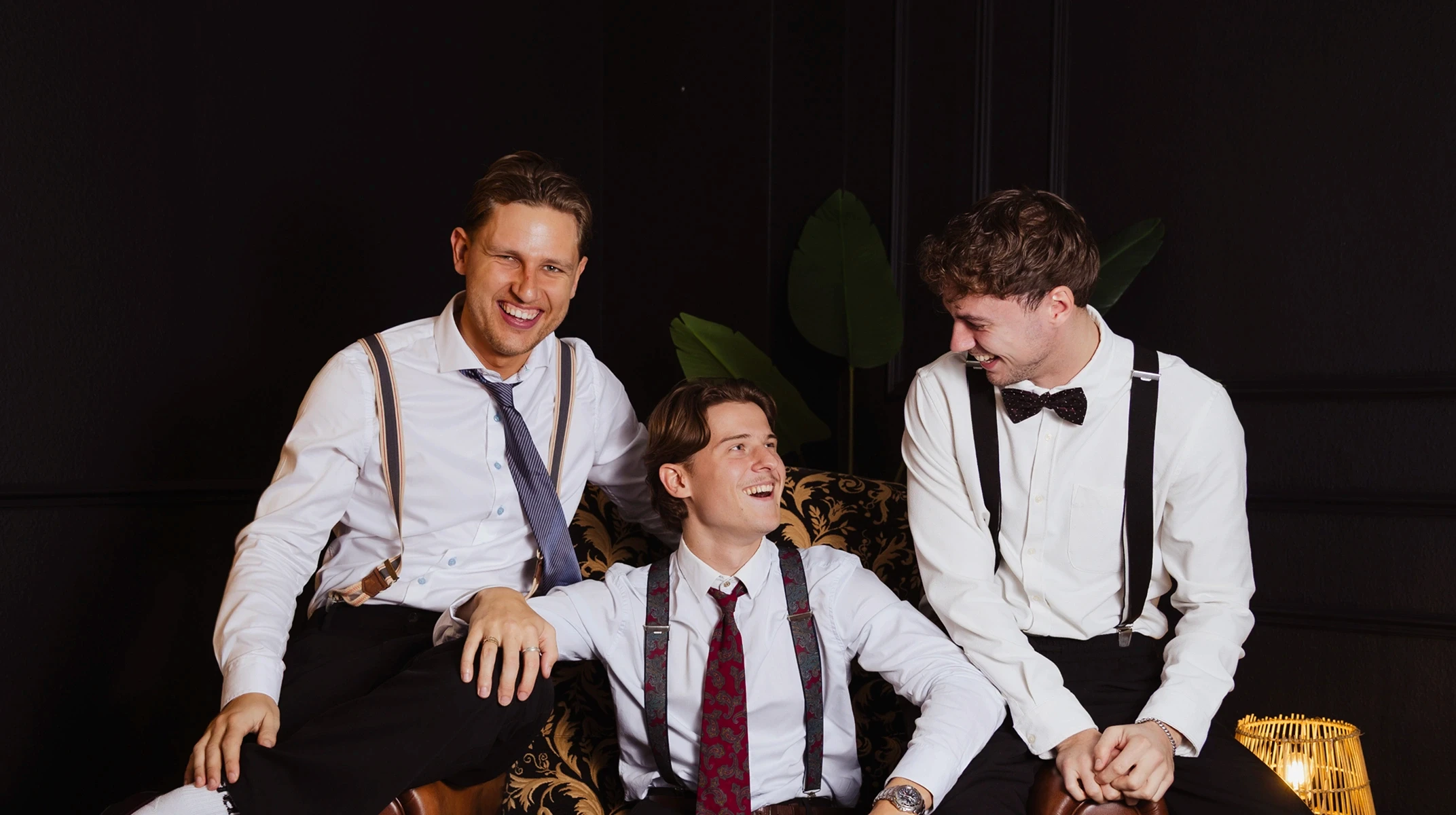 A red hot air balloon glows at sunset over mountains.