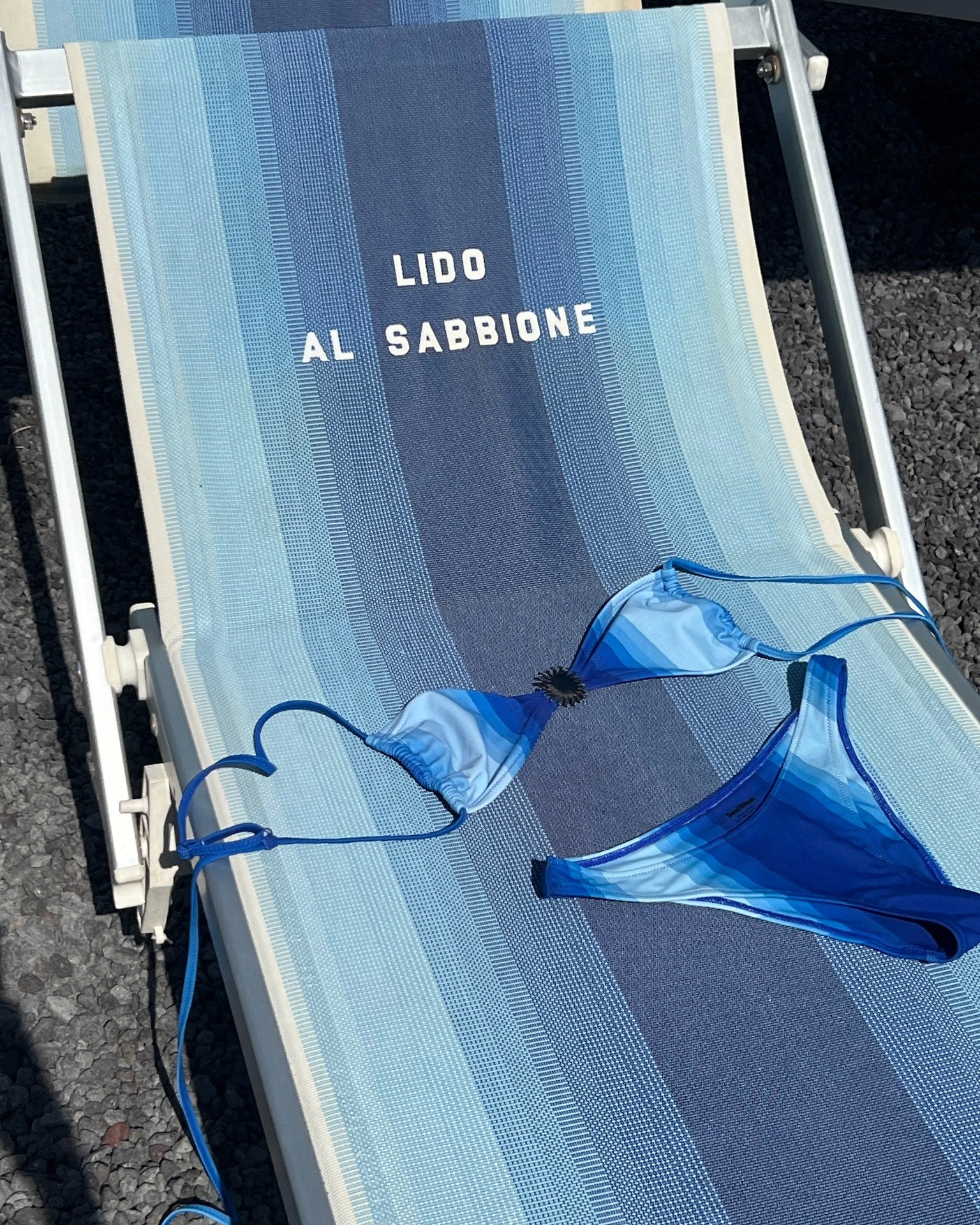 a group of people standing on top of a sandy beach