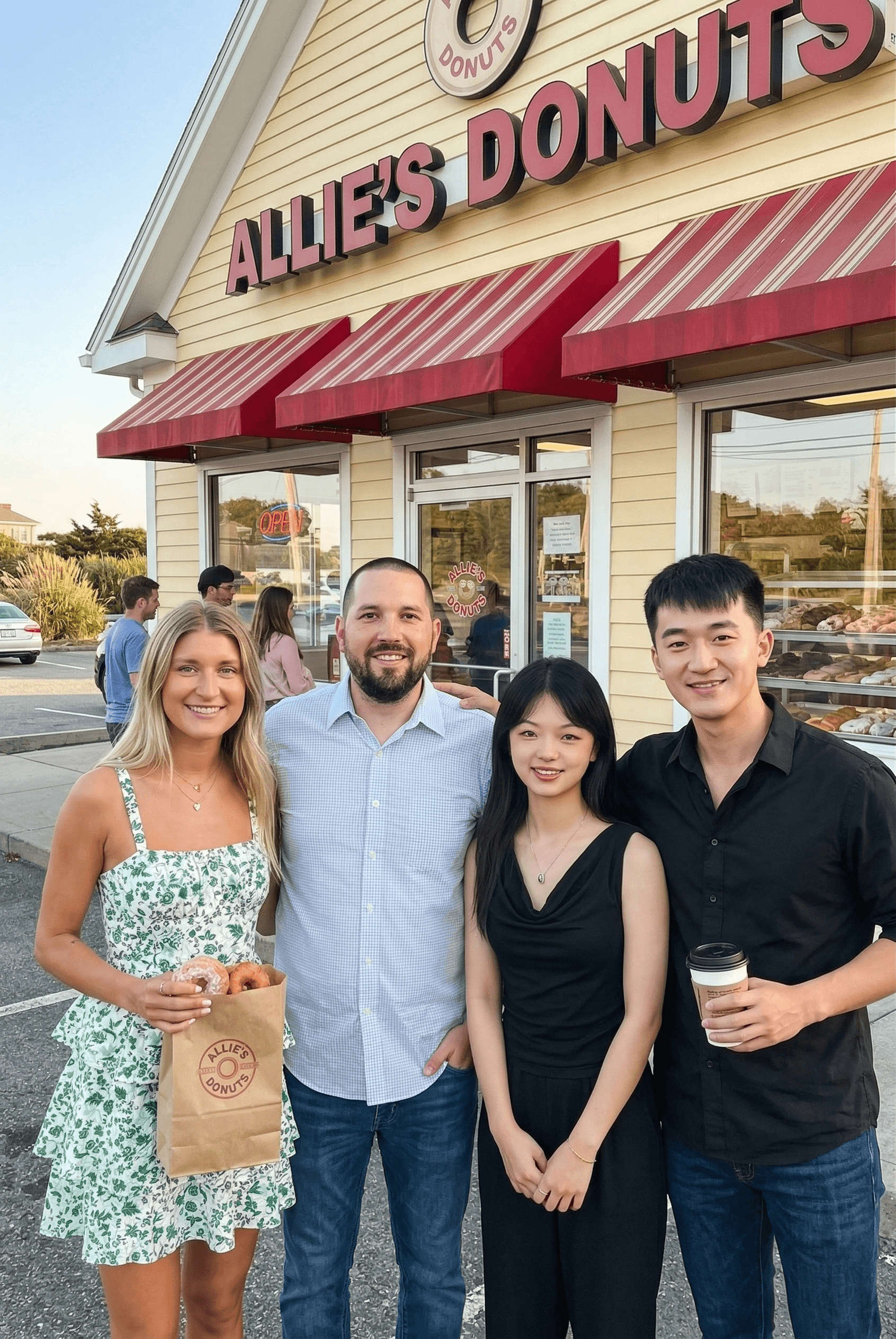 Group of diverse colleagues smiling and looking at laptop together in office.