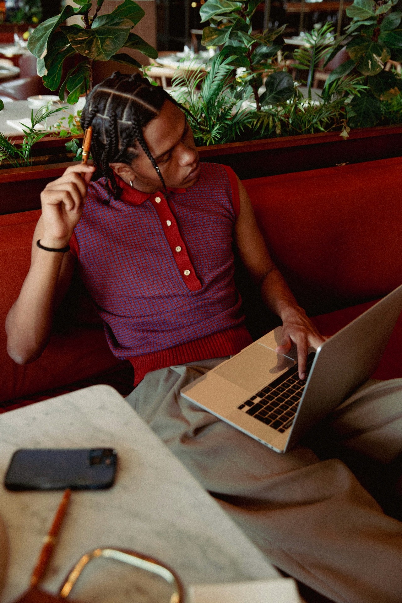 A person sitting on a sofa using a laptop in a relaxed indoor setting.