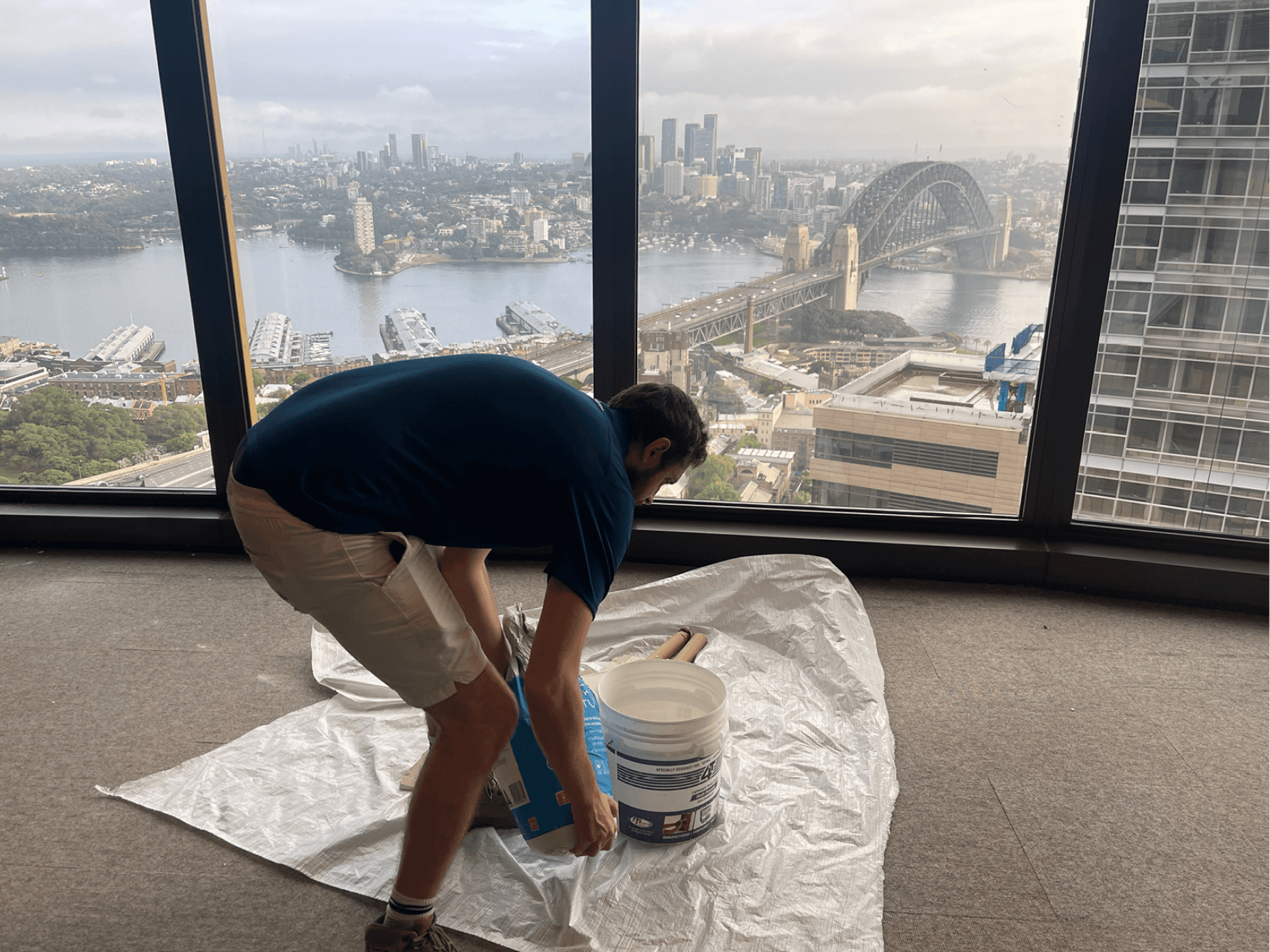 Man pouring powder into a bucket.