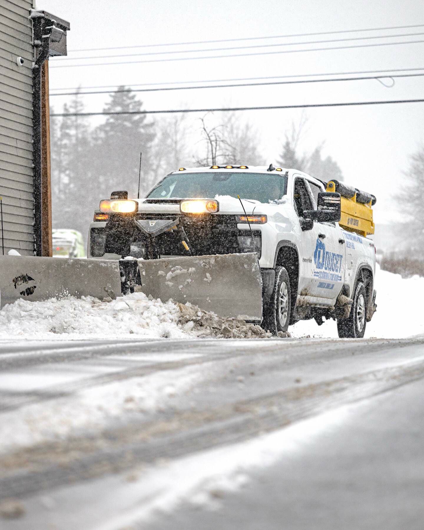 Doucet plow truck clearing snow during a storm