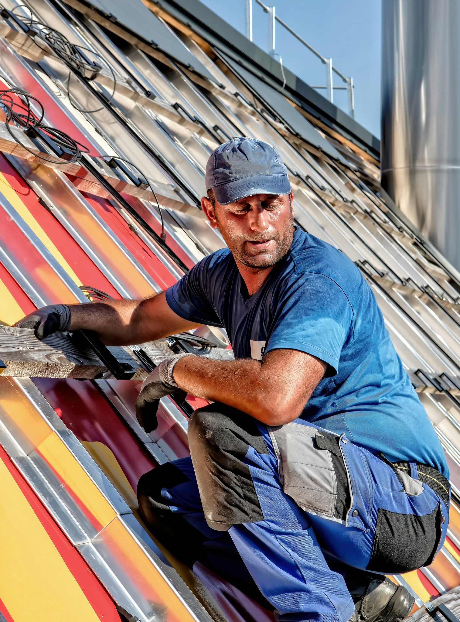 a person wearing a cap installing solar panel 