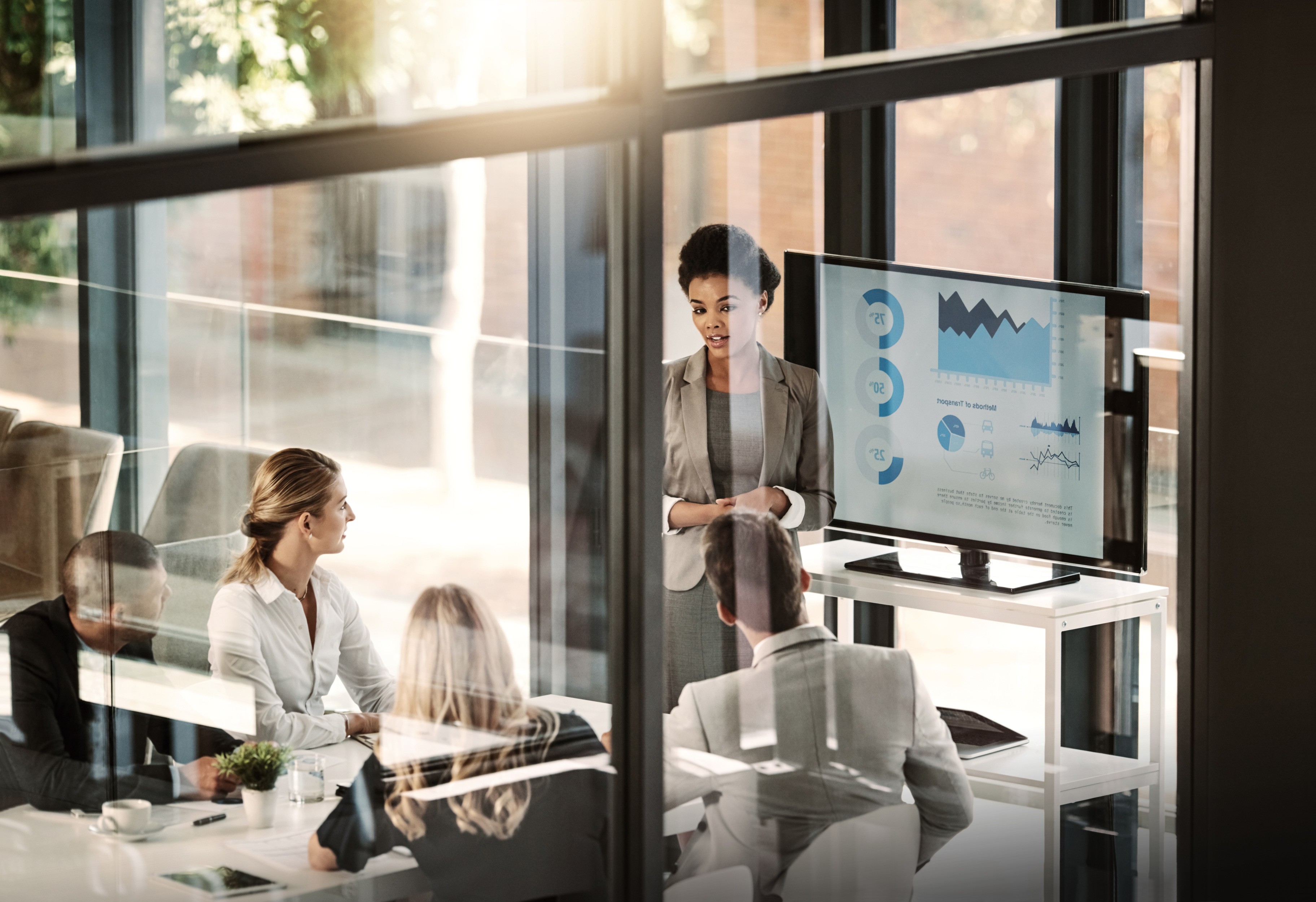 woman in brown coat using macbook air