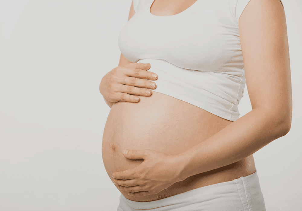 Pregnant woman cradling her baby bump