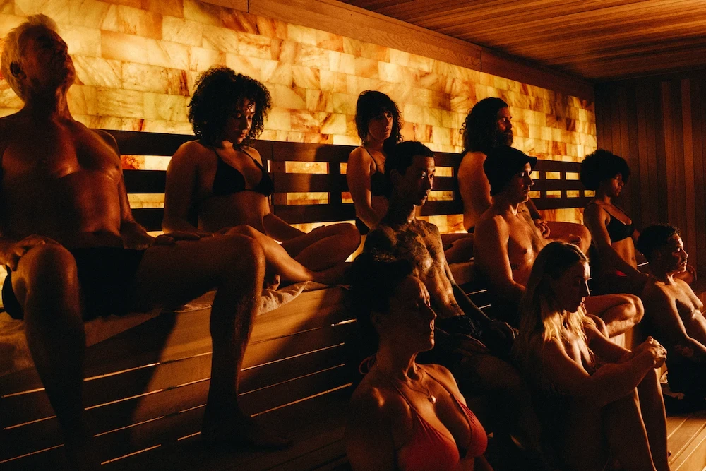 Group seated together in a communal sauna session, reflecting the social and ritual aspects shared by Russian banya and German Aufguss traditions.
