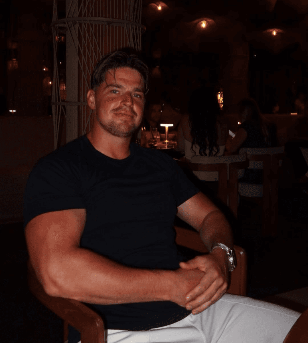 man standing beside wall