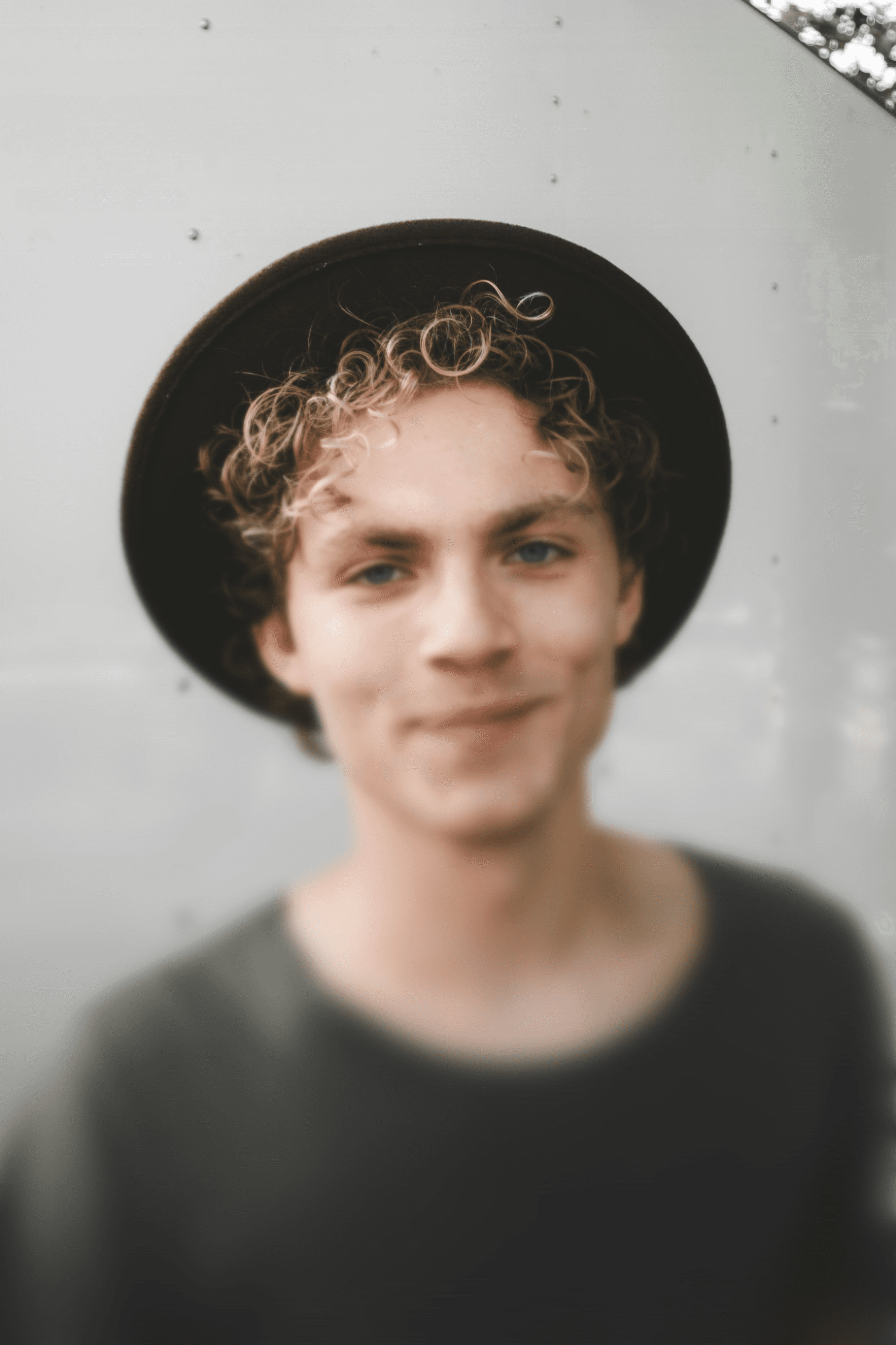 man standing near white wall