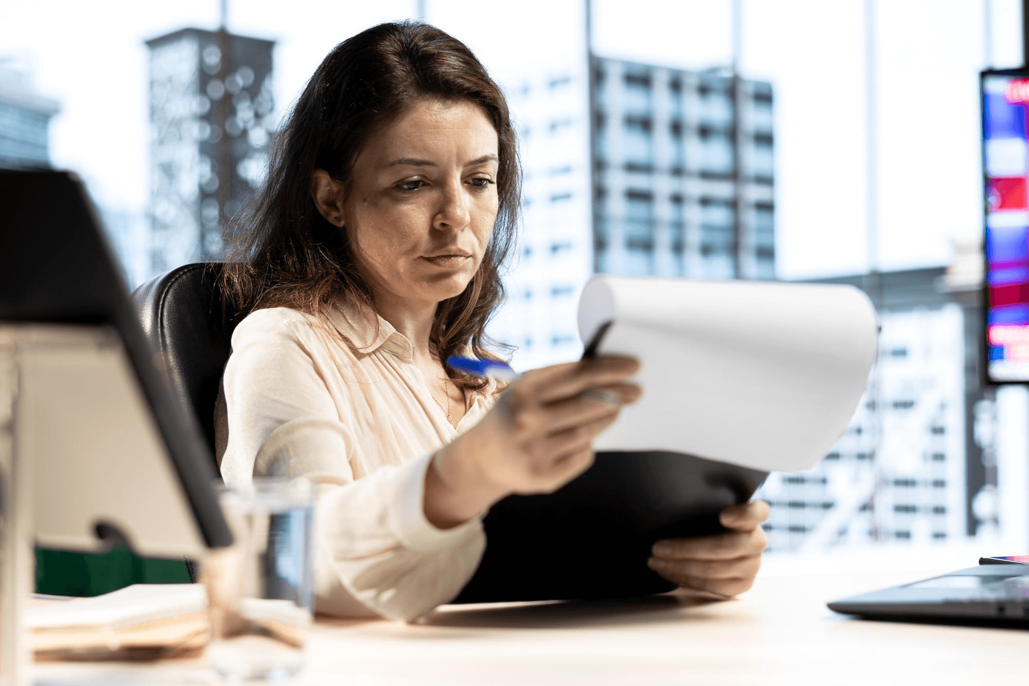 Female employee reviewing guidelines for regulatory compliance.