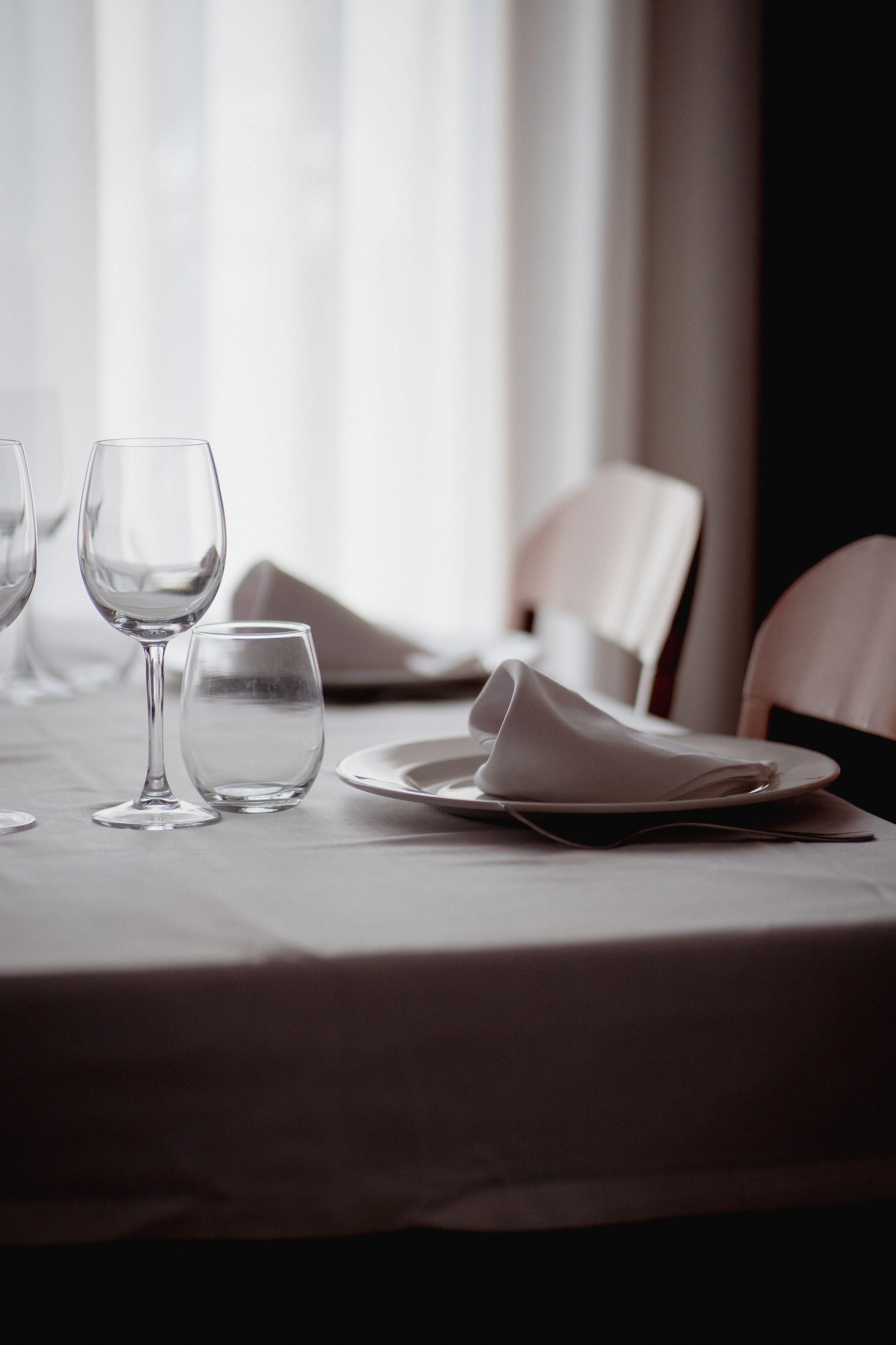 Posh restaurant interior with blue walls and large chandelier in the center