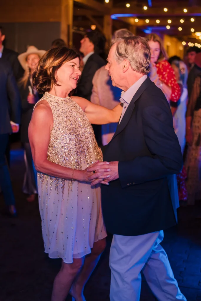 Two wedding guests dancing together at the reception