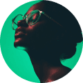 A woman in silhouette with large glasses gazes upward. The image is lit with a dramatic green and dark shadow contrast, creating a contemplative mood.