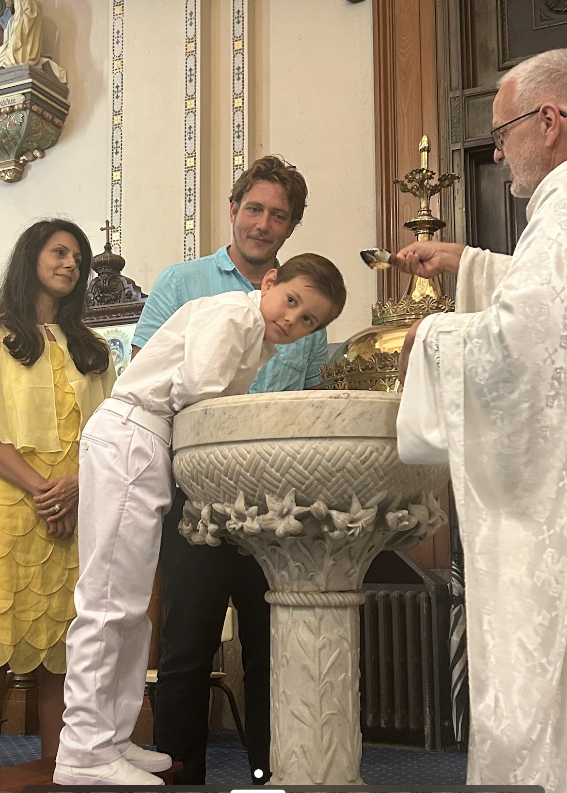 A priest preparing the holy water for a baptism