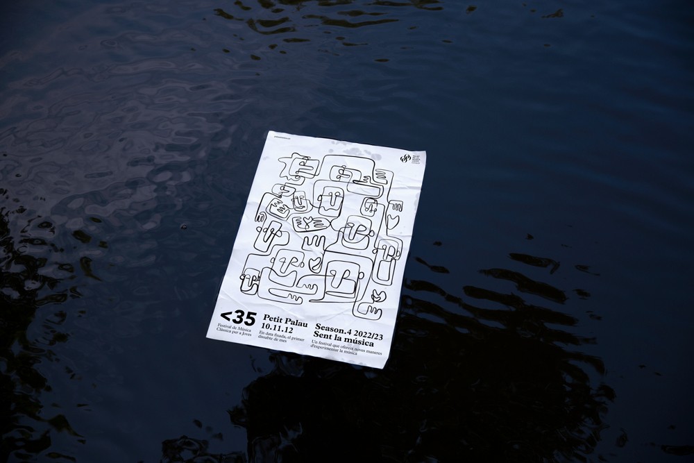 Ett mindre än 35 tryckt program med fet svart och vit typografi som ligger på en mörk blöt yta, som används som projektets thumbnail för OUF Studios kulturella varumärkesfall.