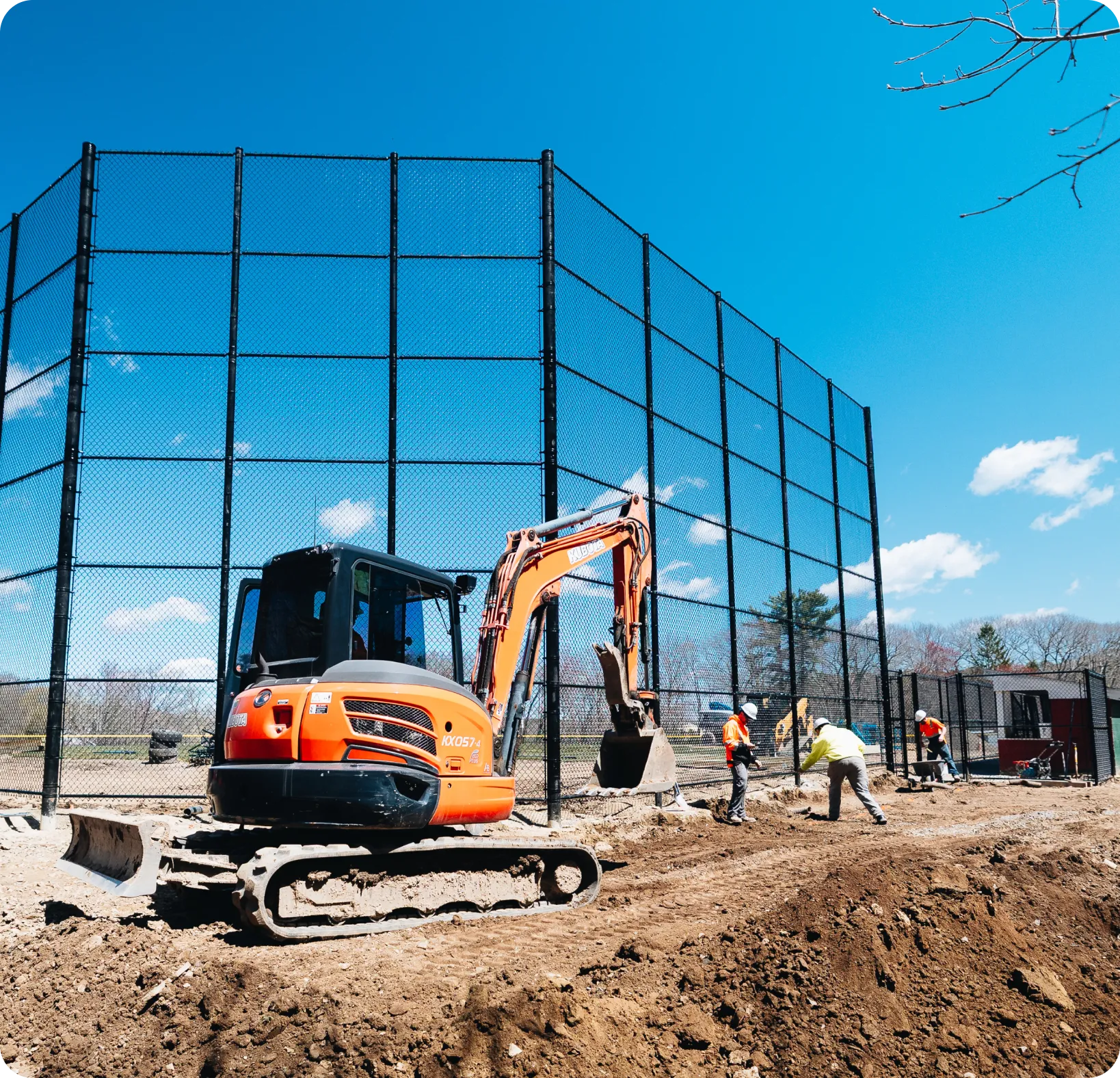 Price Landscape and Construction onsite with an excavator at a baseball field with employees working
