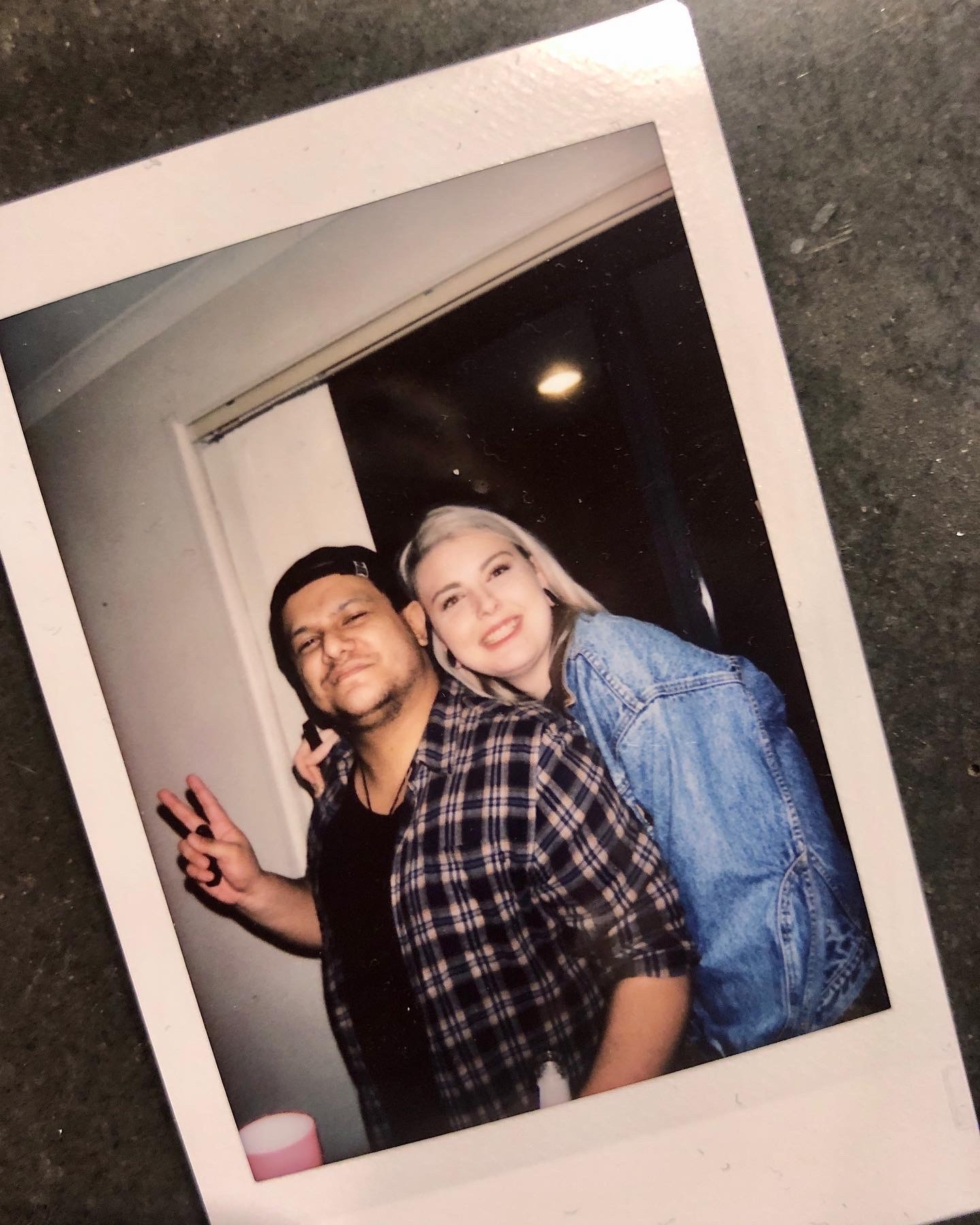 Two gold wedding rings rest atop a soft, textured fabric with a subtle pattern. The rings shine under gentle light, evoking themes of love and commitment.