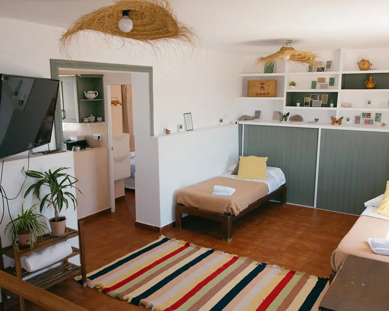 Helles Gemeinschaftszimmer mit zwei Einzelbetten und gemütlicher Einrichtung im Tarifa Surf House