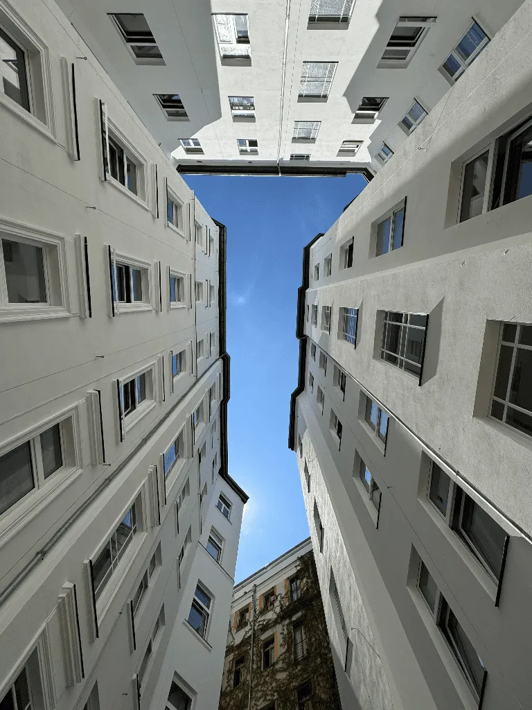 White buildings with windows and a blue sky