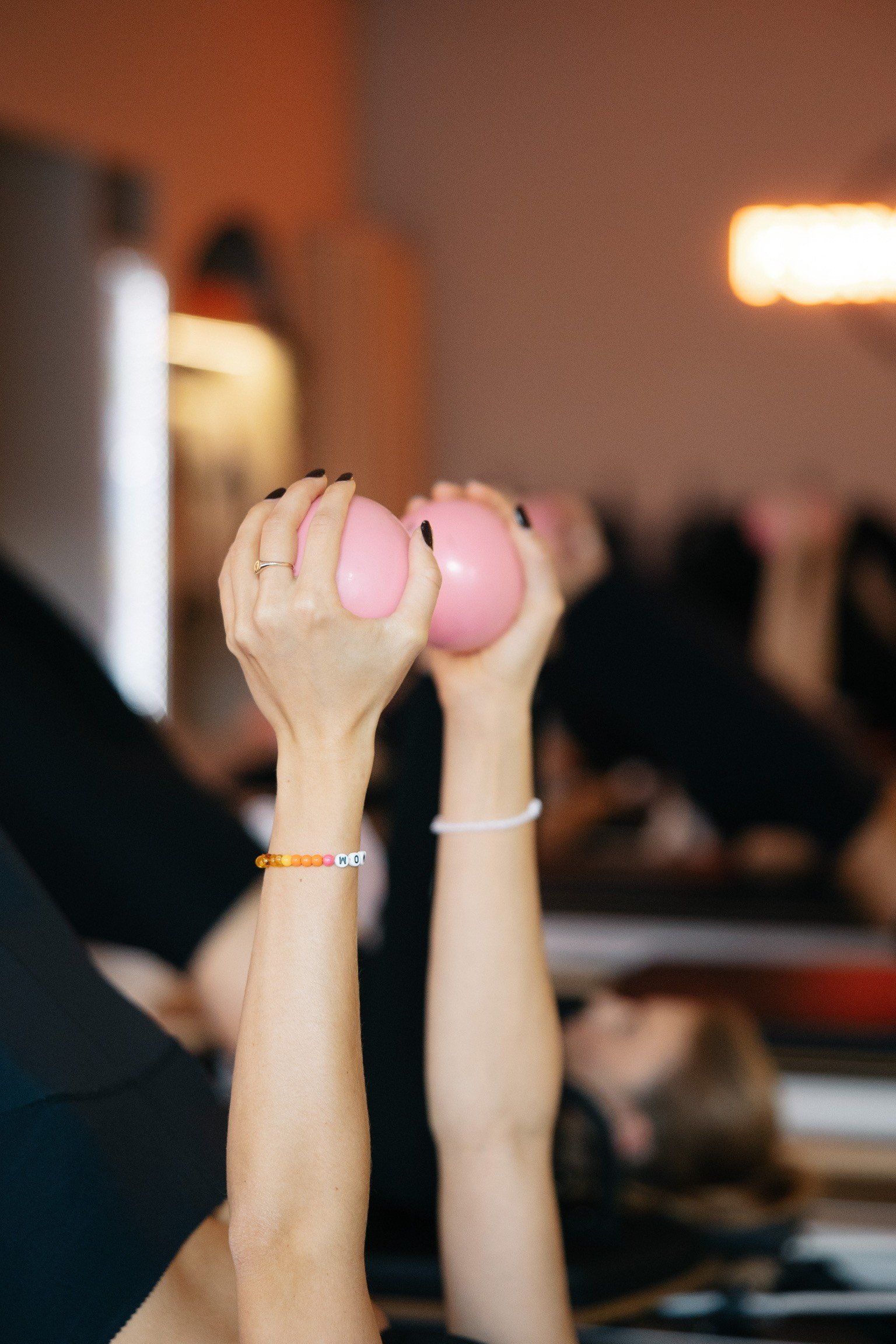 Woman practicing aerial yoga with white hammock