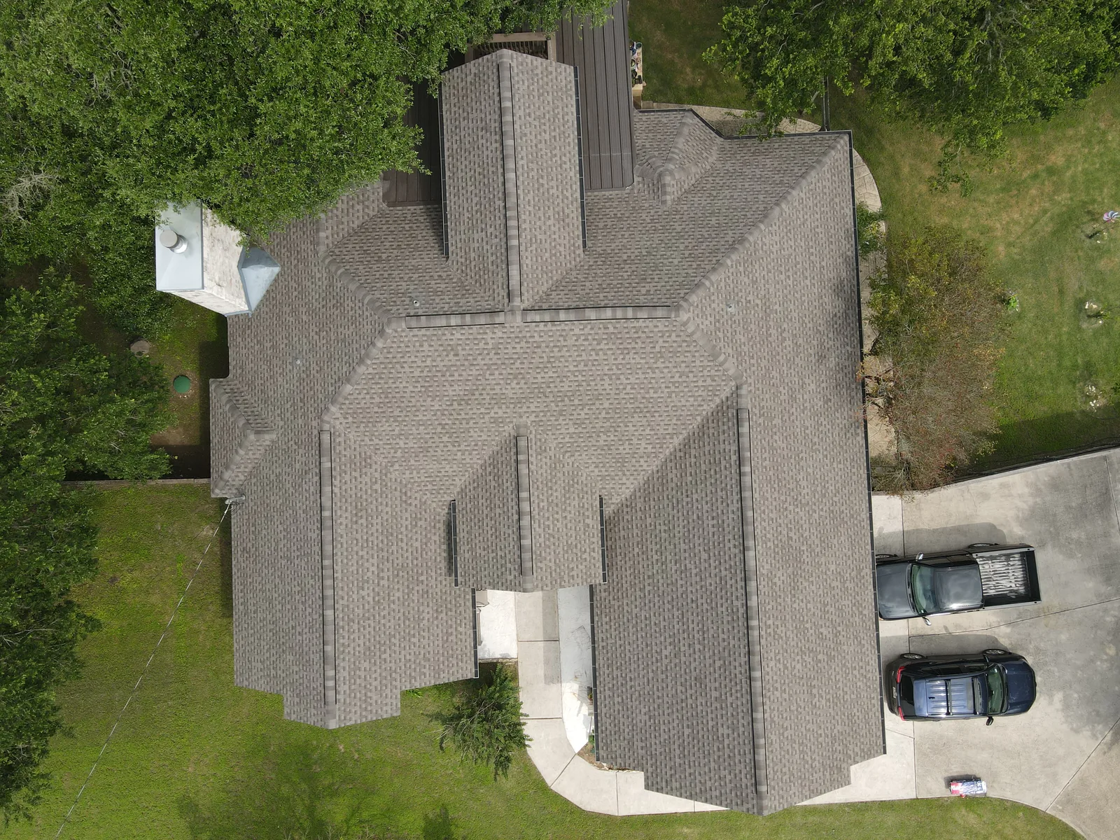 After - another angle: shingles around a stone chimney.