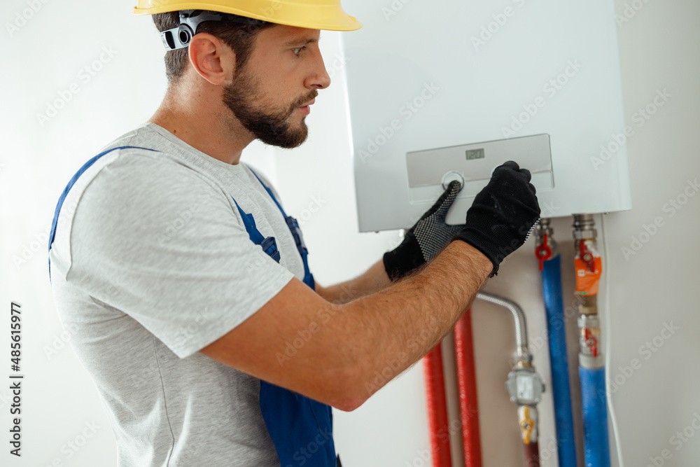 An emergency plumber fixing a leaky pipe in a bathroom 