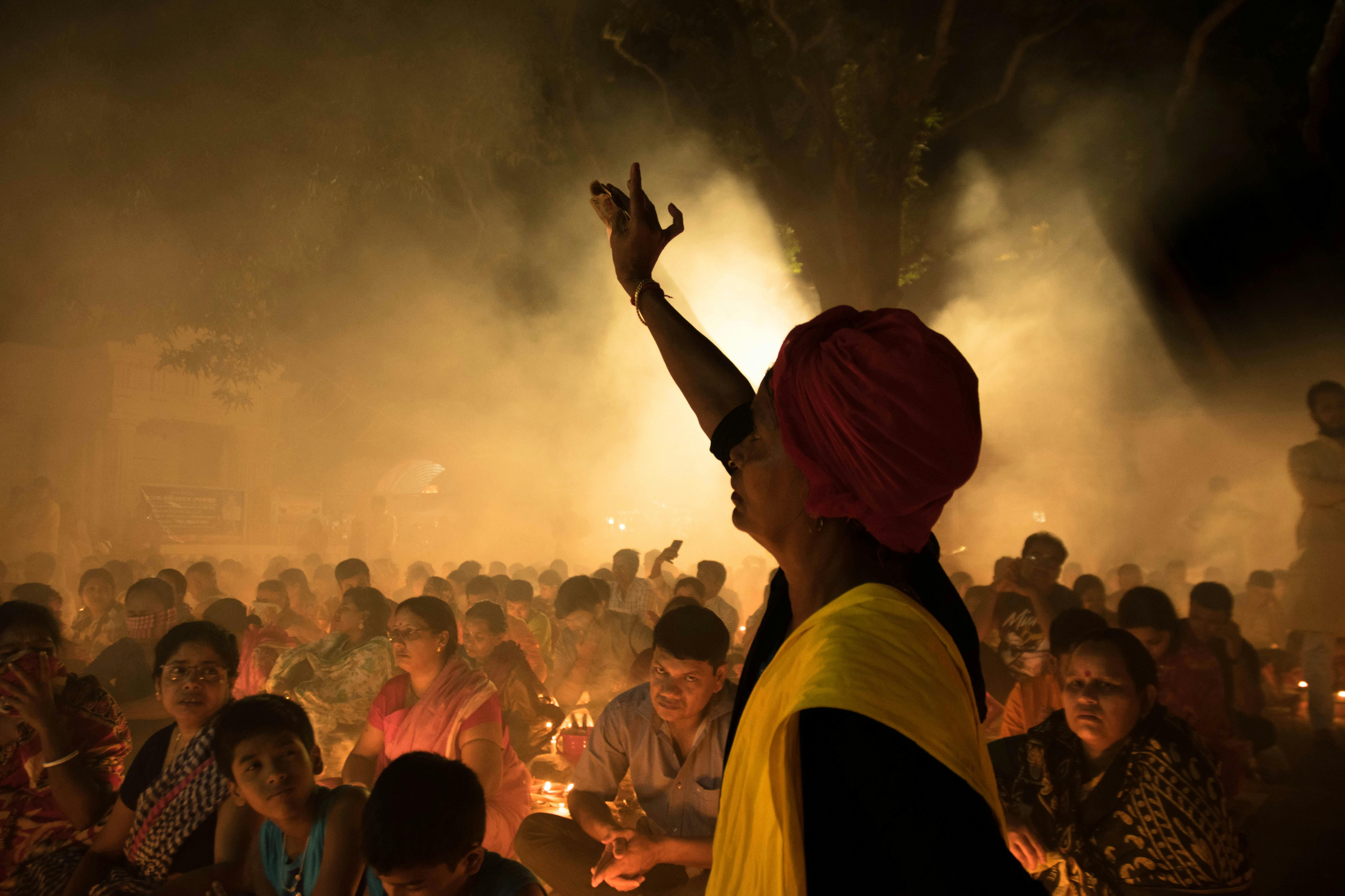 person raising hand in vedic ritual