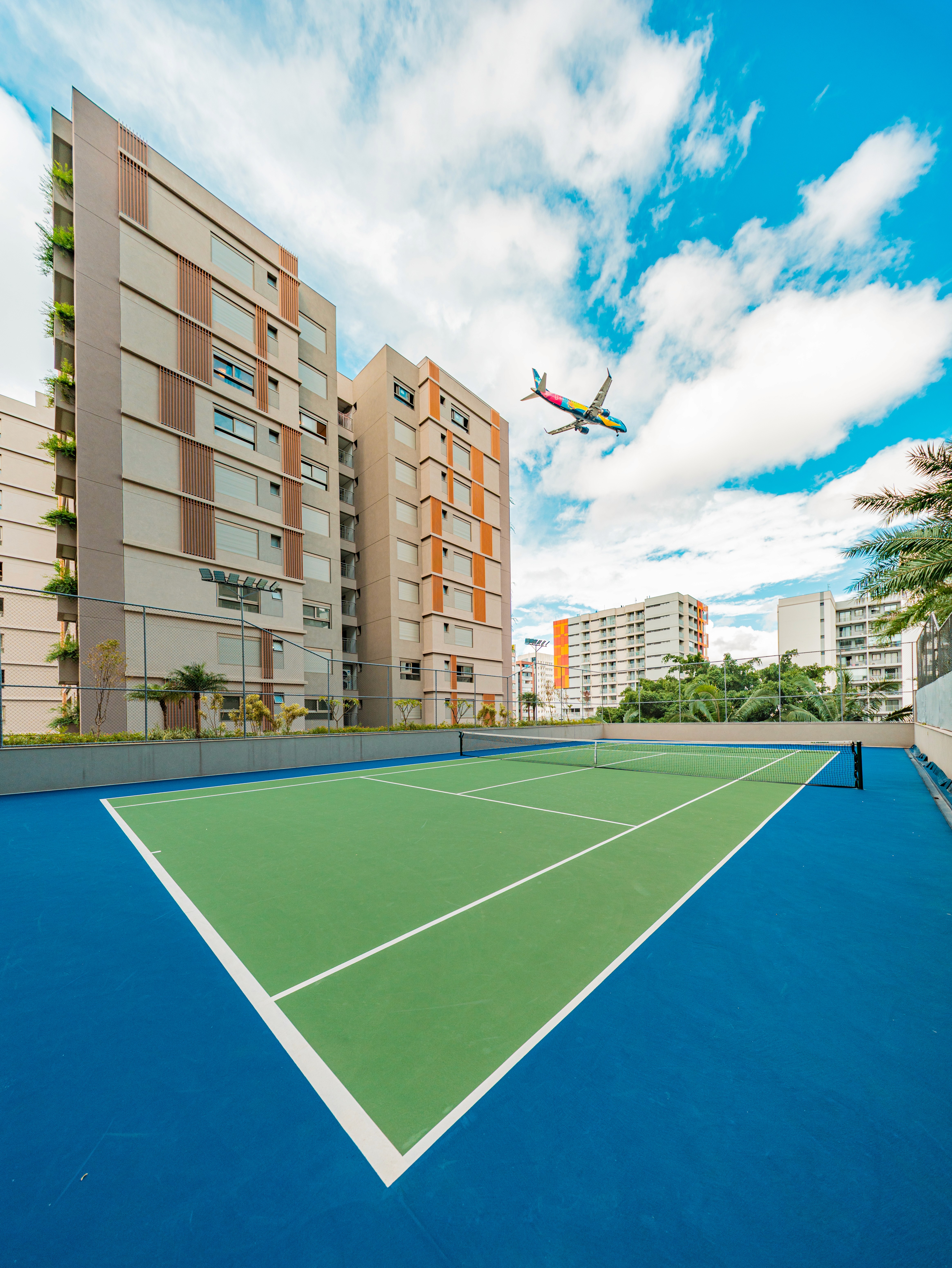 Curved modern skyscraper against a clear blue sky.