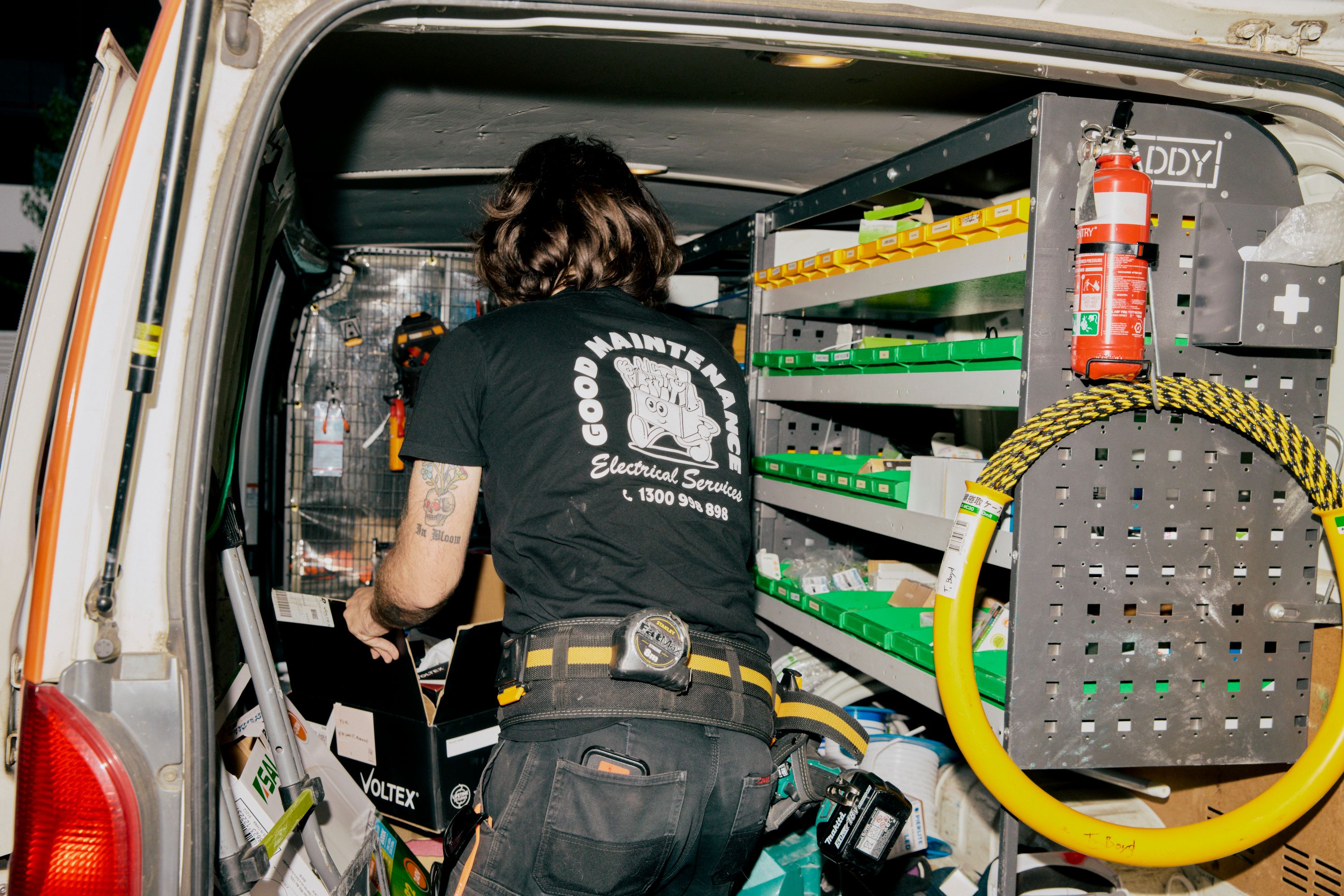 Good Maintenance Electrician looking for electrial parts in the back of a company van.