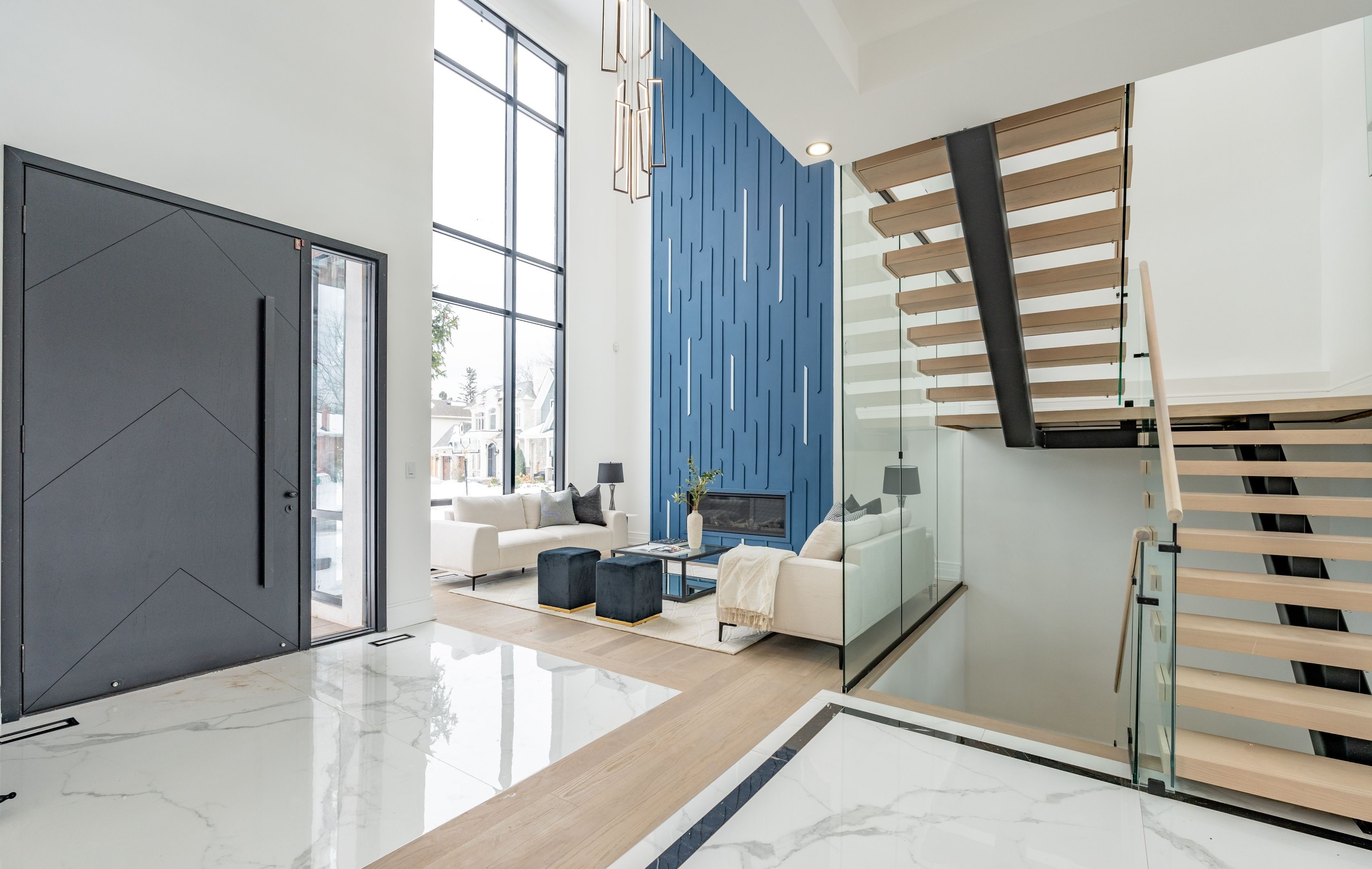 A modern, minimalist cliffside house with large glass windows offers stunning ocean views, surrounded by lush greenery and bathed in warm sunlight.