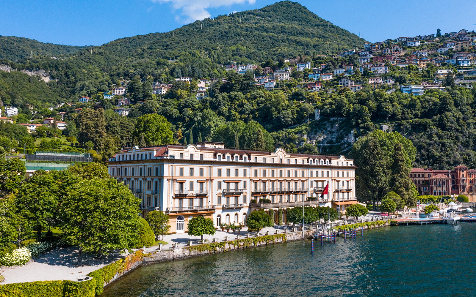 Villa d'Este luxury hotel on Lake Como, Cernobbio, with lush hillside backdrop.