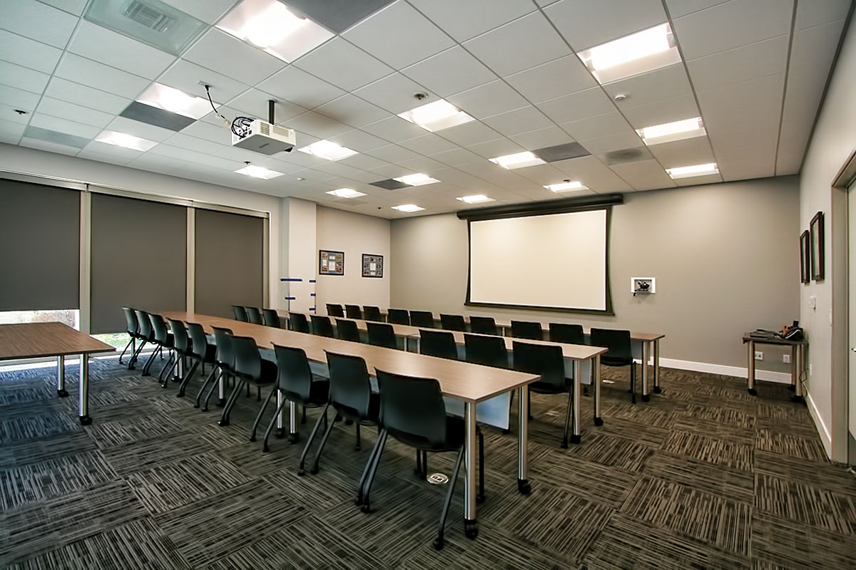 Team meeting room with a projector screen, designed for collaboration and presentations.