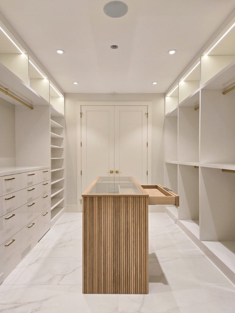 Image of Luxury primary ensuites feature spacious walk-in closets with custom furniture and layout design by KHD Homes.