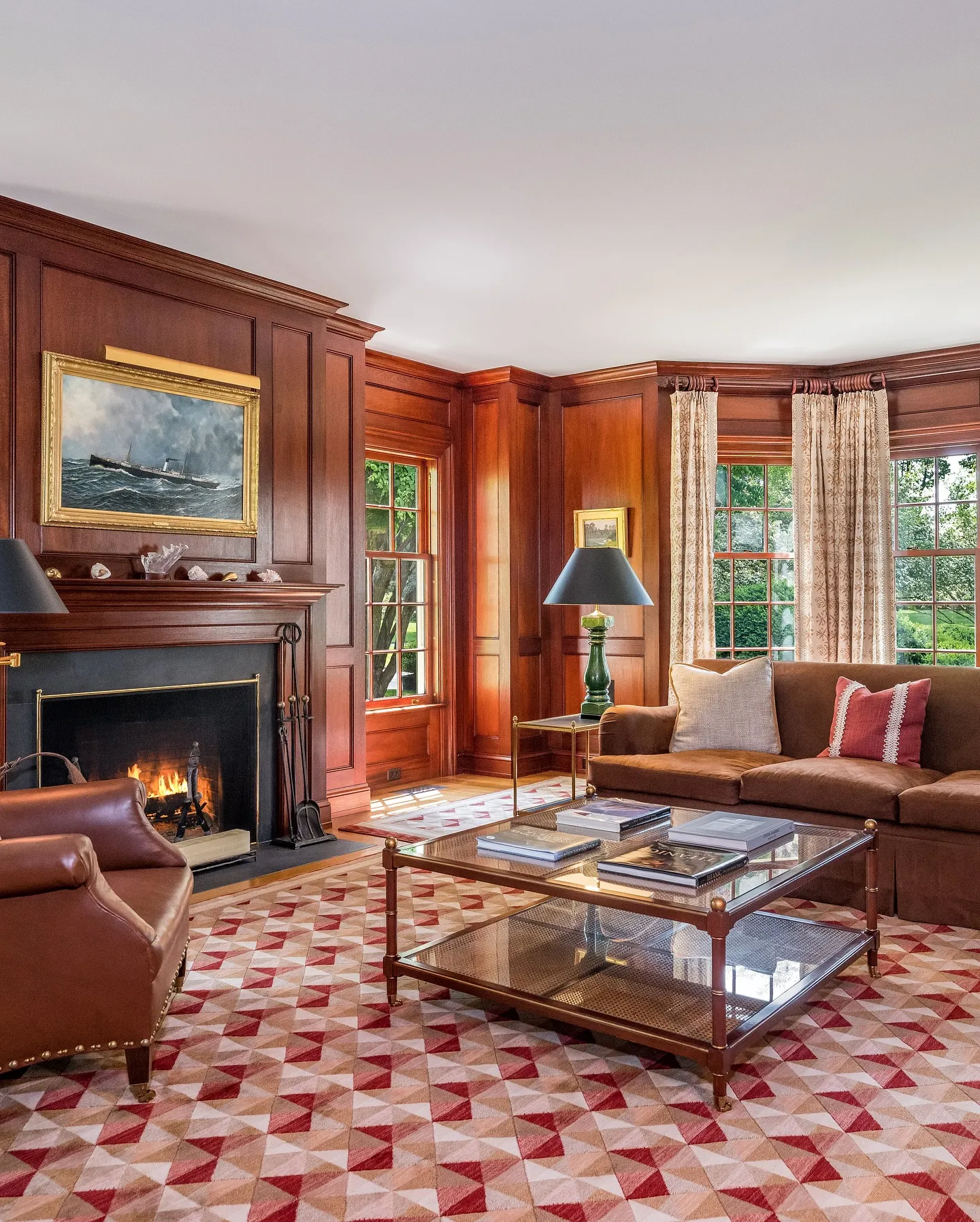 A cozy living room with a fireplace, artwork, and comfortable seating.
